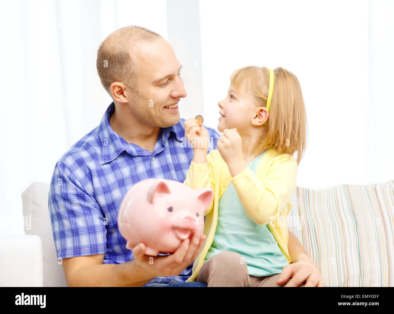 happy father and daughter with big piggy bank Stock Photo - Alamy