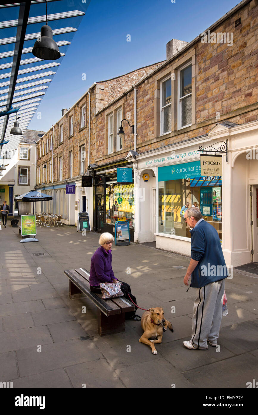 UK, England, Lancashire, Lancaster, Marketgate, shoppers resting on town centre bench Stock Photo