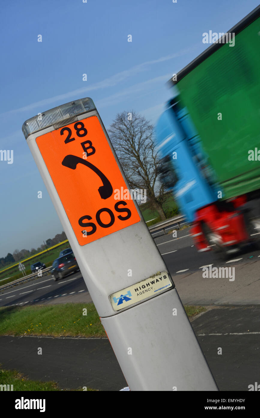 lorry passing sos emergency breakdown telephone on the a64 road near york yorkshire uk Stock Photo
