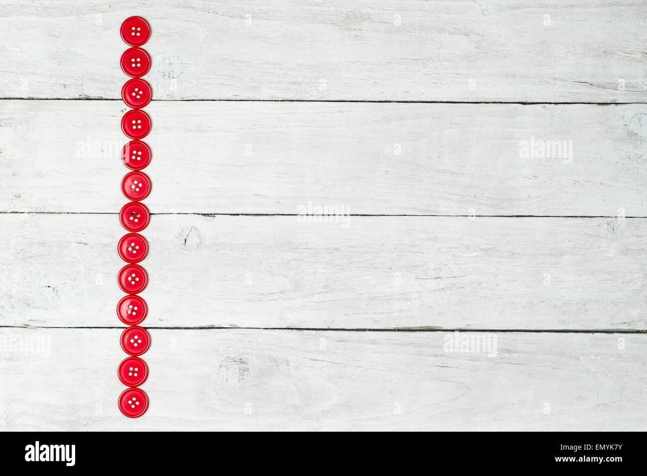 Sewing buttons on a wooden tiled background Stock Photo - Alamy