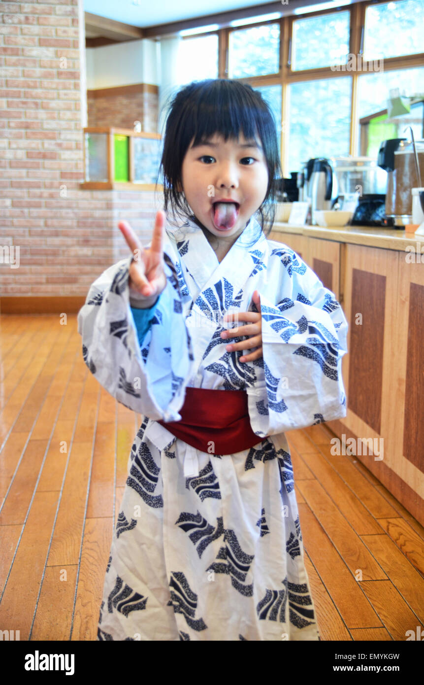 Cute Japanese girl doing a 'peace' sign Stock Photo