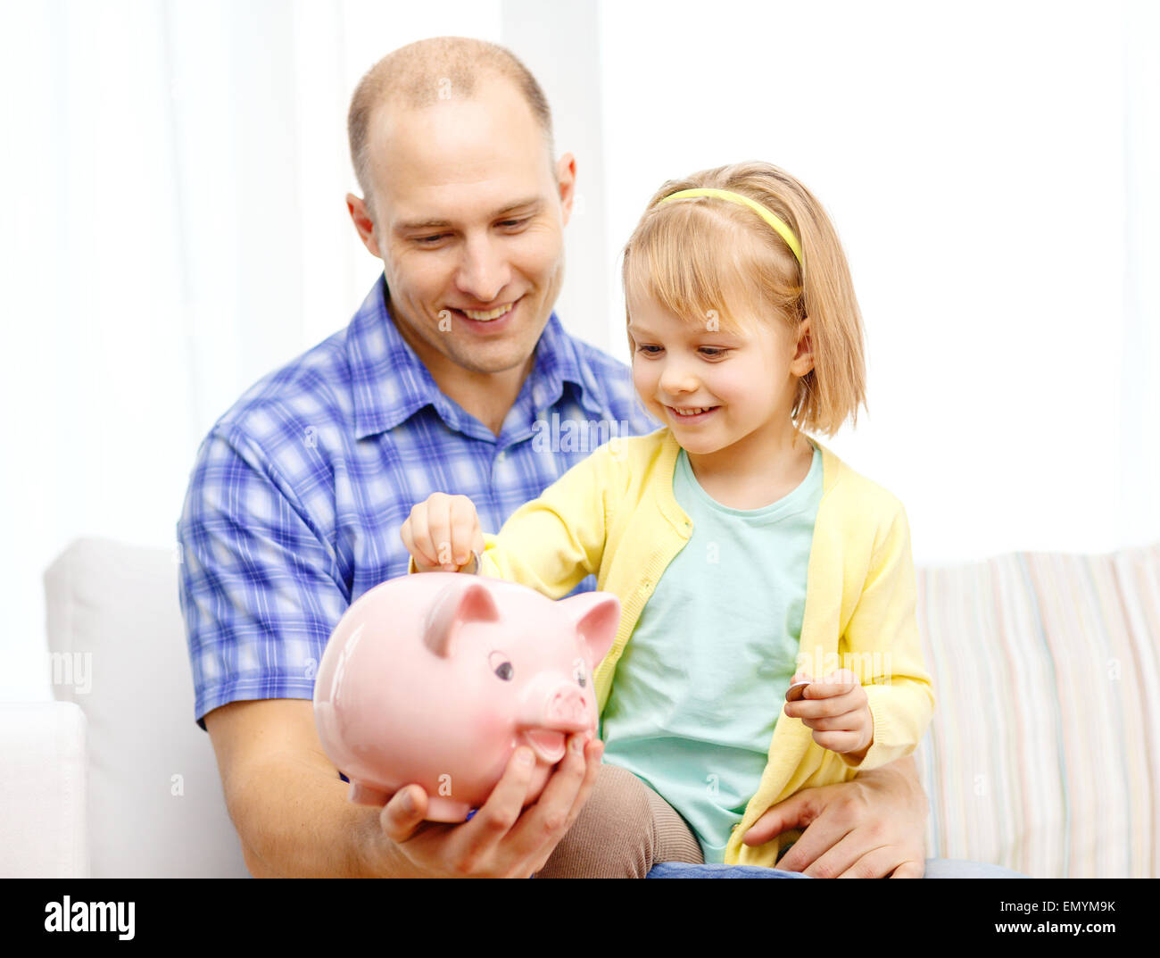 happy father and daughter with big piggy bank Stock Photo - Alamy
