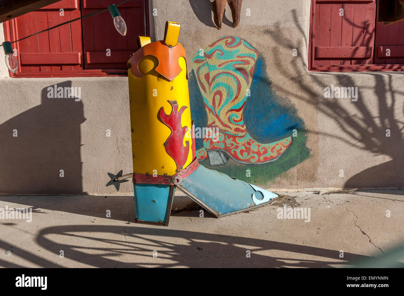 Metal cowboy boots sculpture and mural. Downtown Alpine. Texas. USA Stock Photo