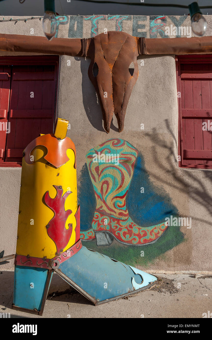 Metal cowboy boots sculpture and mural. Downtown Alpine. Texas. USA Stock Photo