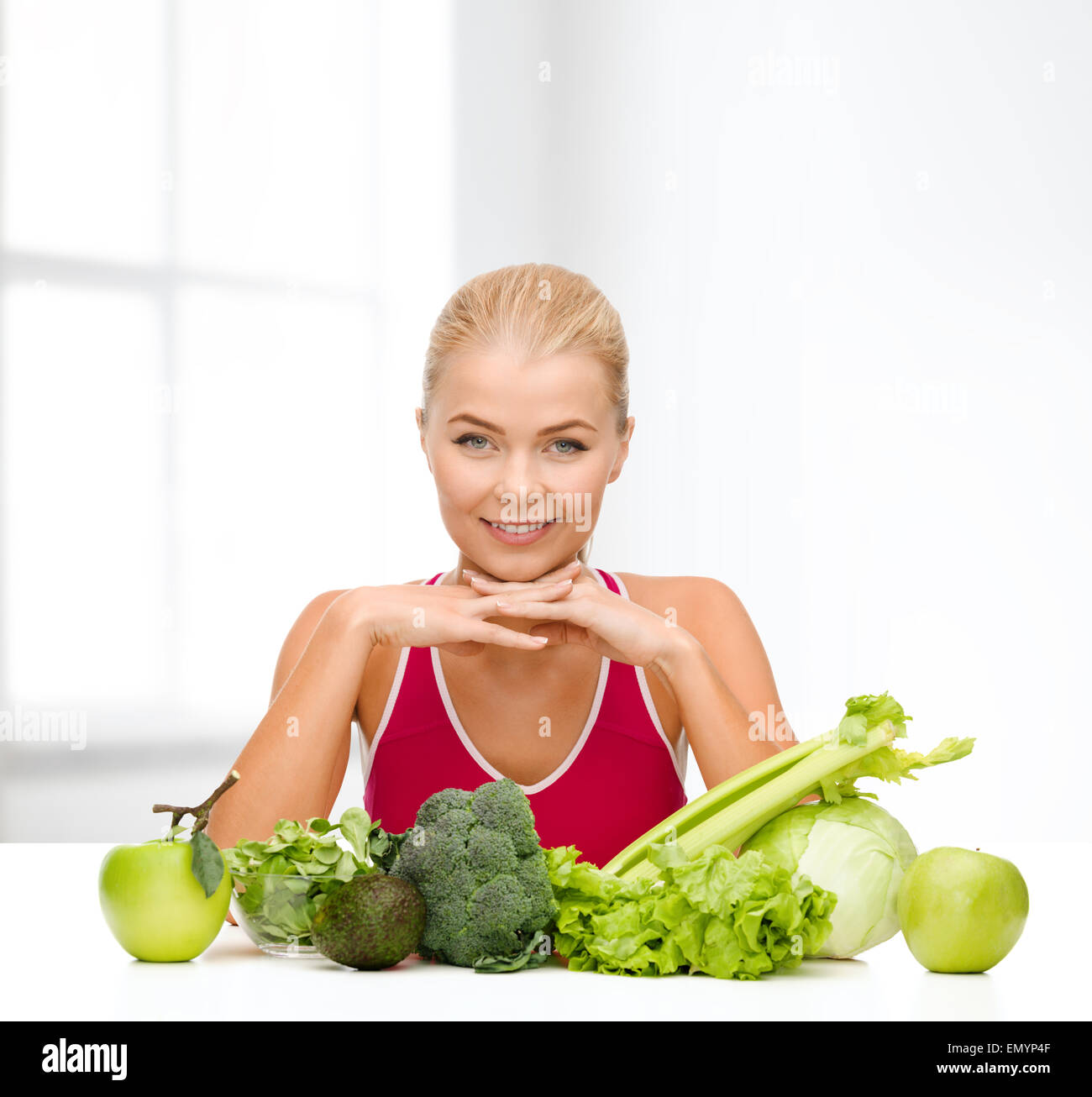 smiling sporty woman with organic food Stock Photo - Alamy