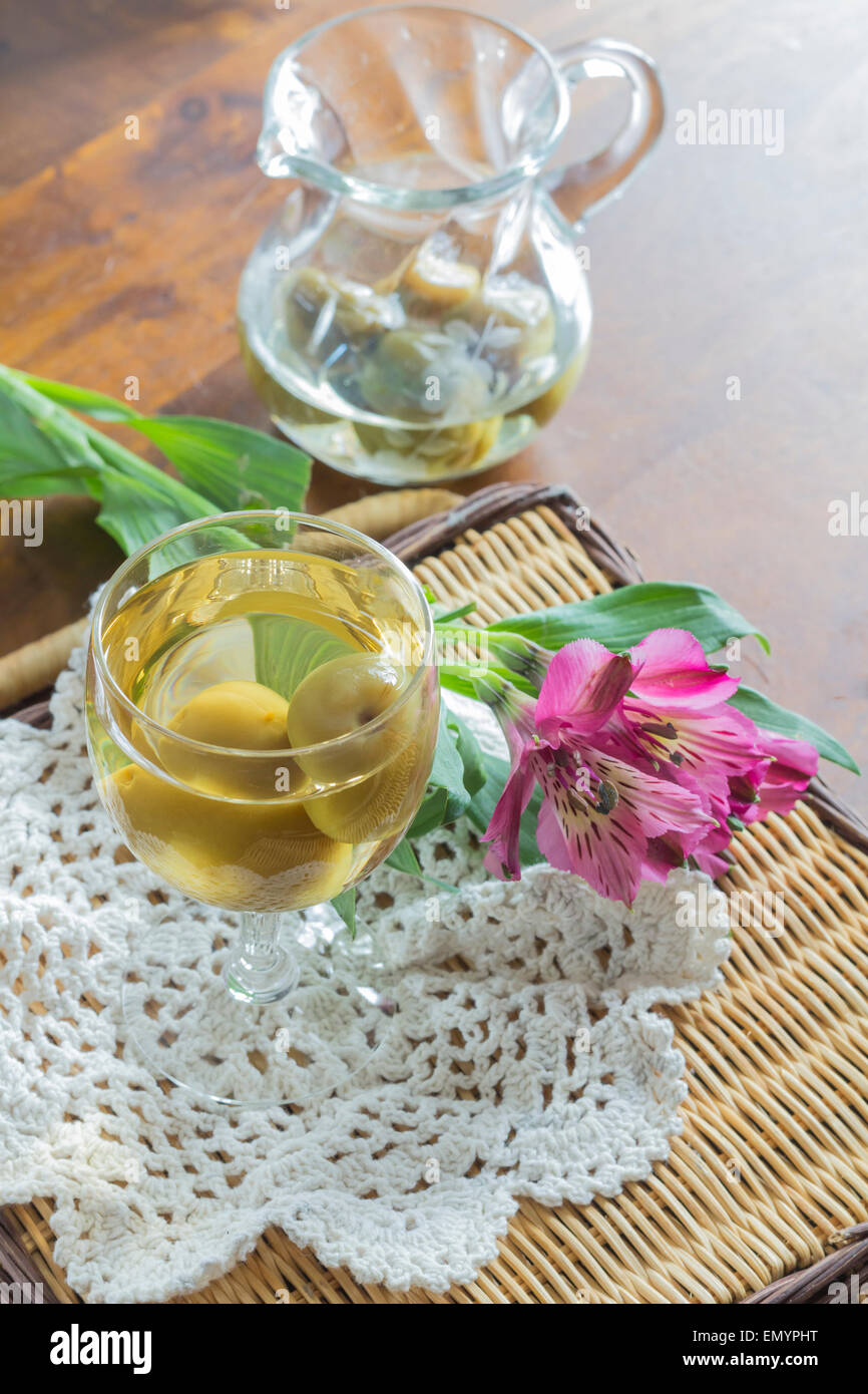 Sweet Japanese plum wine with fruit in glass photographed with