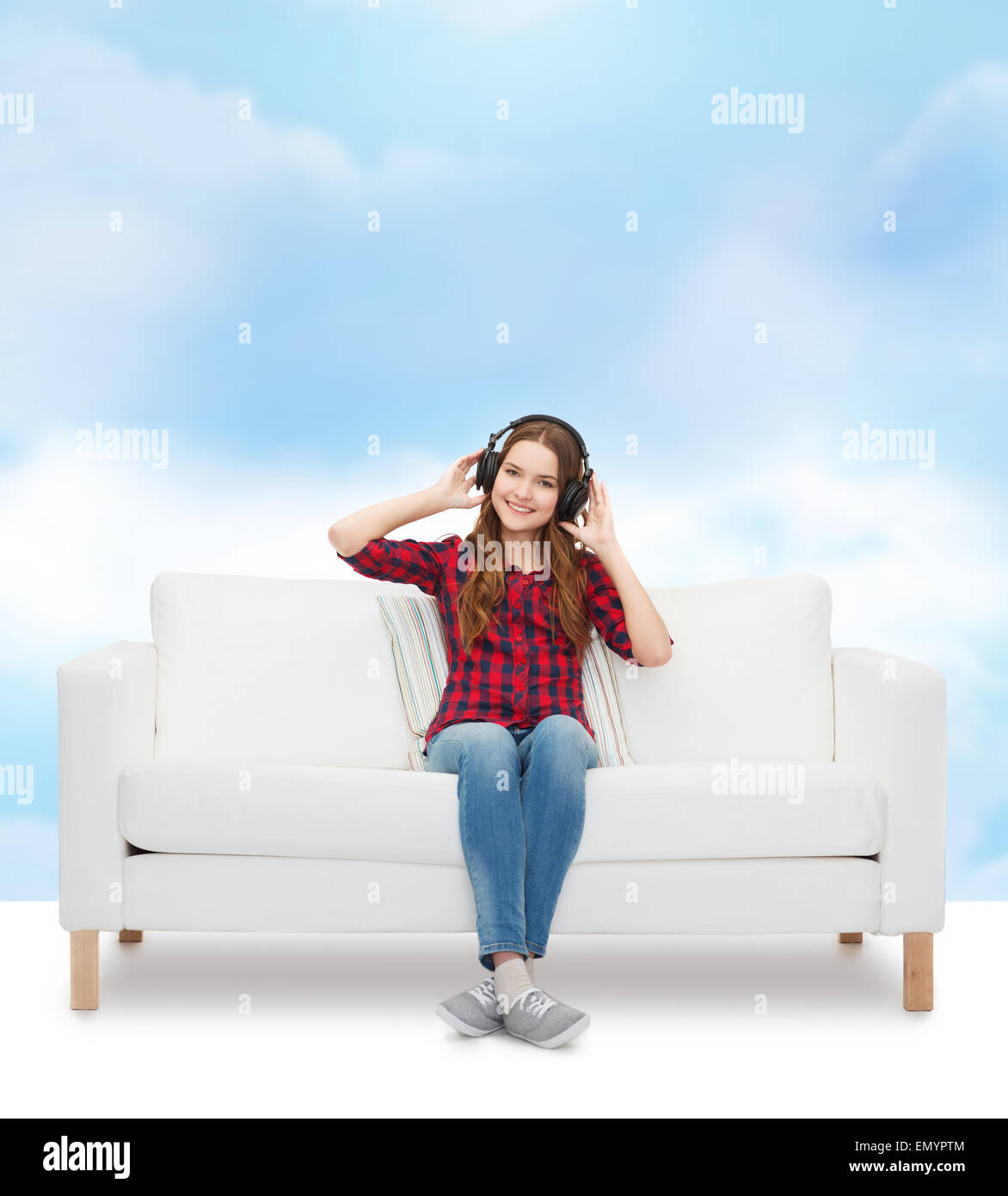 teenage girl sitting on sofa with headphones Stock Photo - Alamy