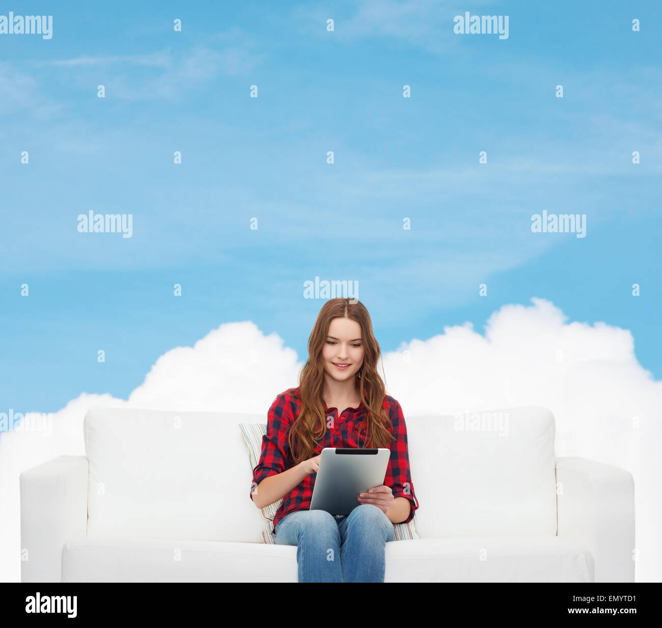 teenage girl sitting on sofa with tablet pc Stock Photo - Alamy