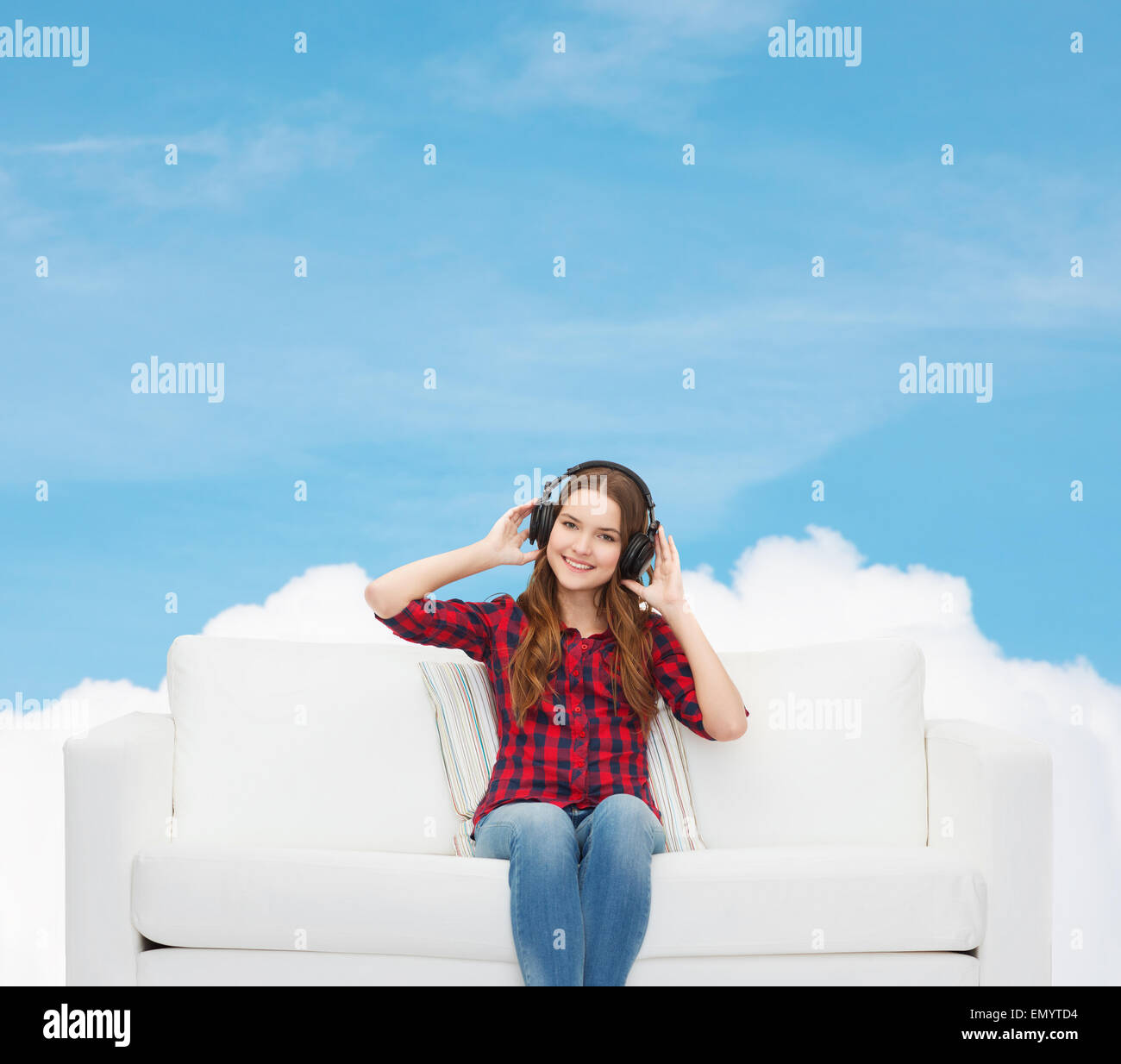 teenage girl sitting on sofa with headphones Stock Photo - Alamy