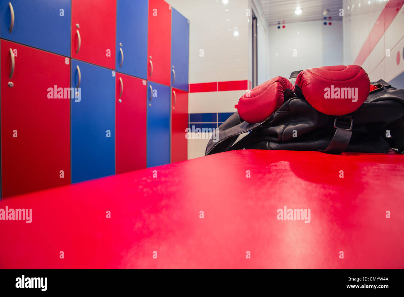 Closeup image of a bag with boxing gloves in locker room Stock Photo ...