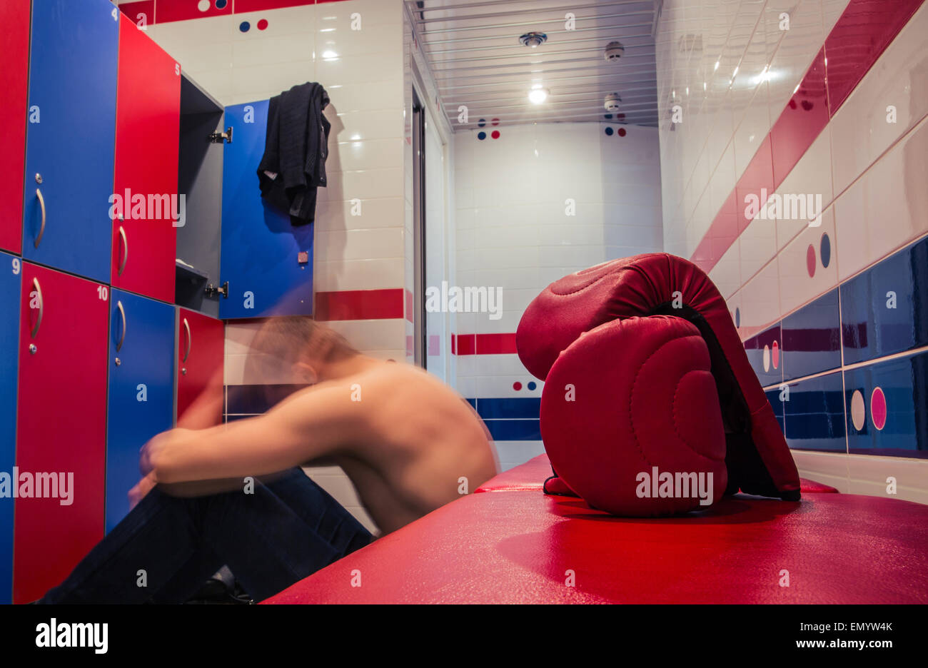 Young man resting in locker room after training Stock Photo