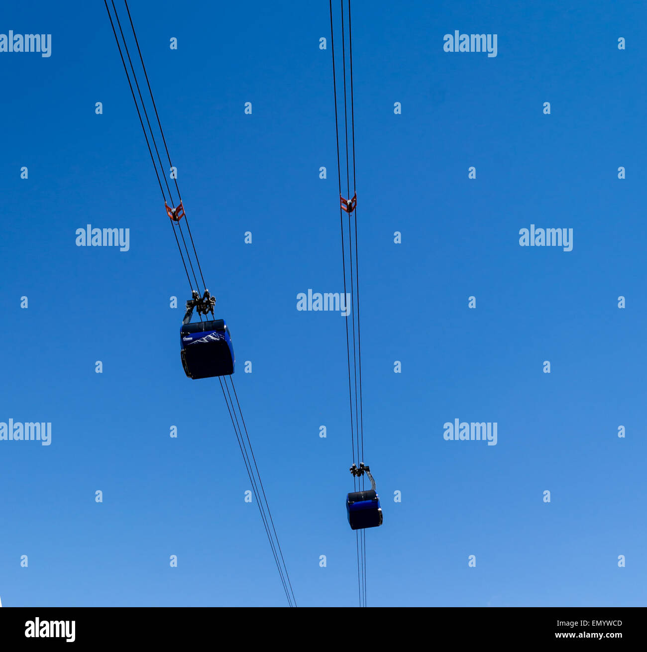 Two Cable Cars meet in a blue sky Stock Photo Alamy