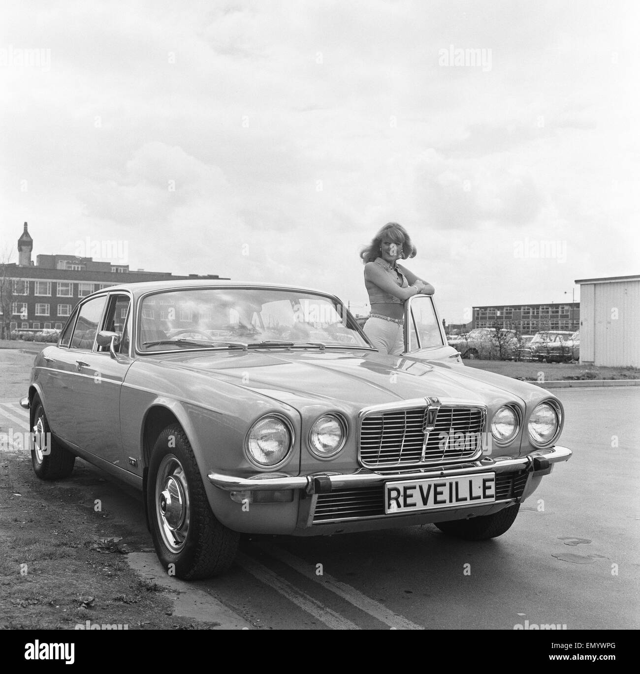 Reveille model seen here posing with a Jaguar XJ12, which is first prize in a Reveille car competition. Circa January 1972 Stock Photo