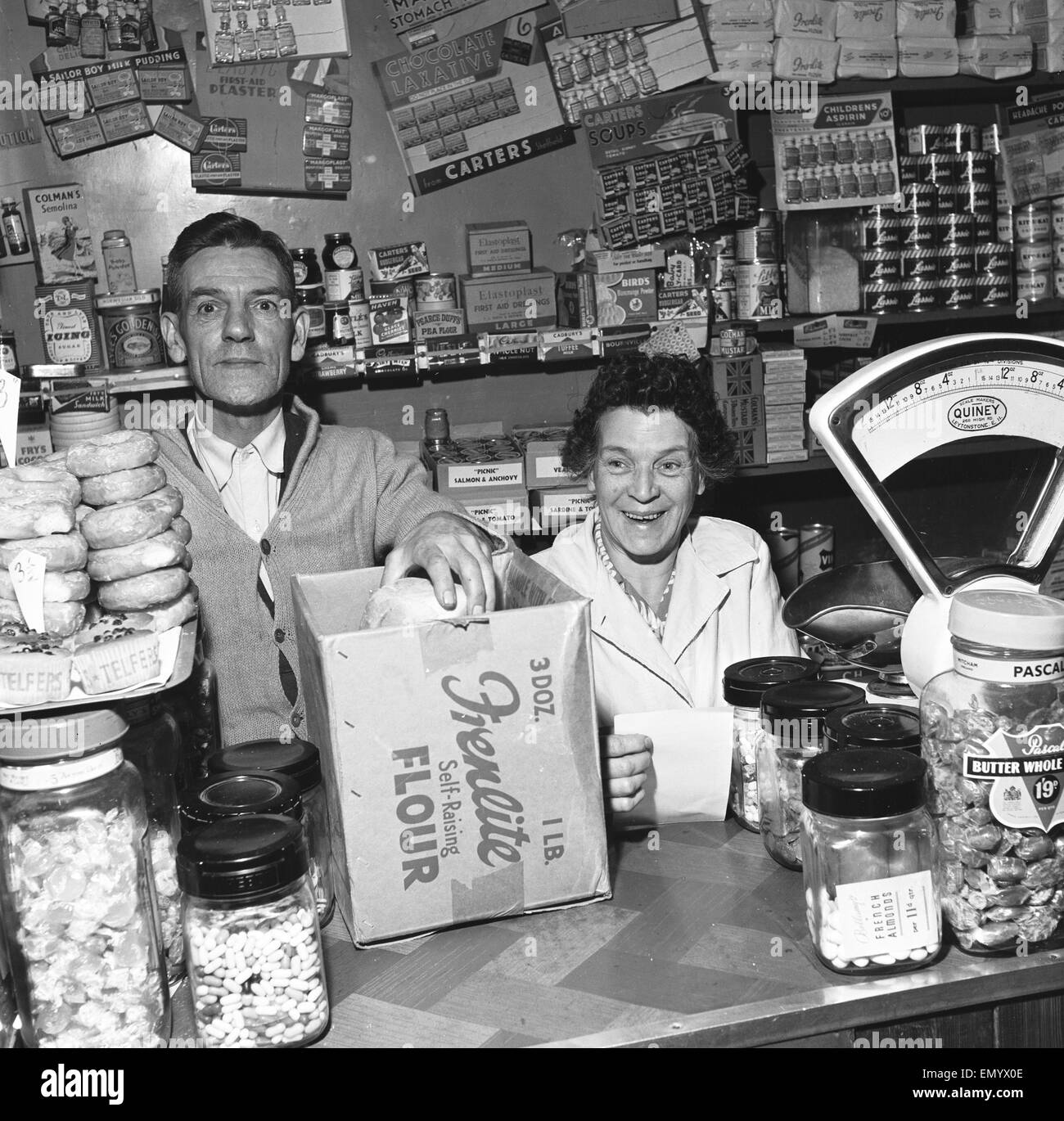 Local grocer and his wife seen here serving a customer. 14th November