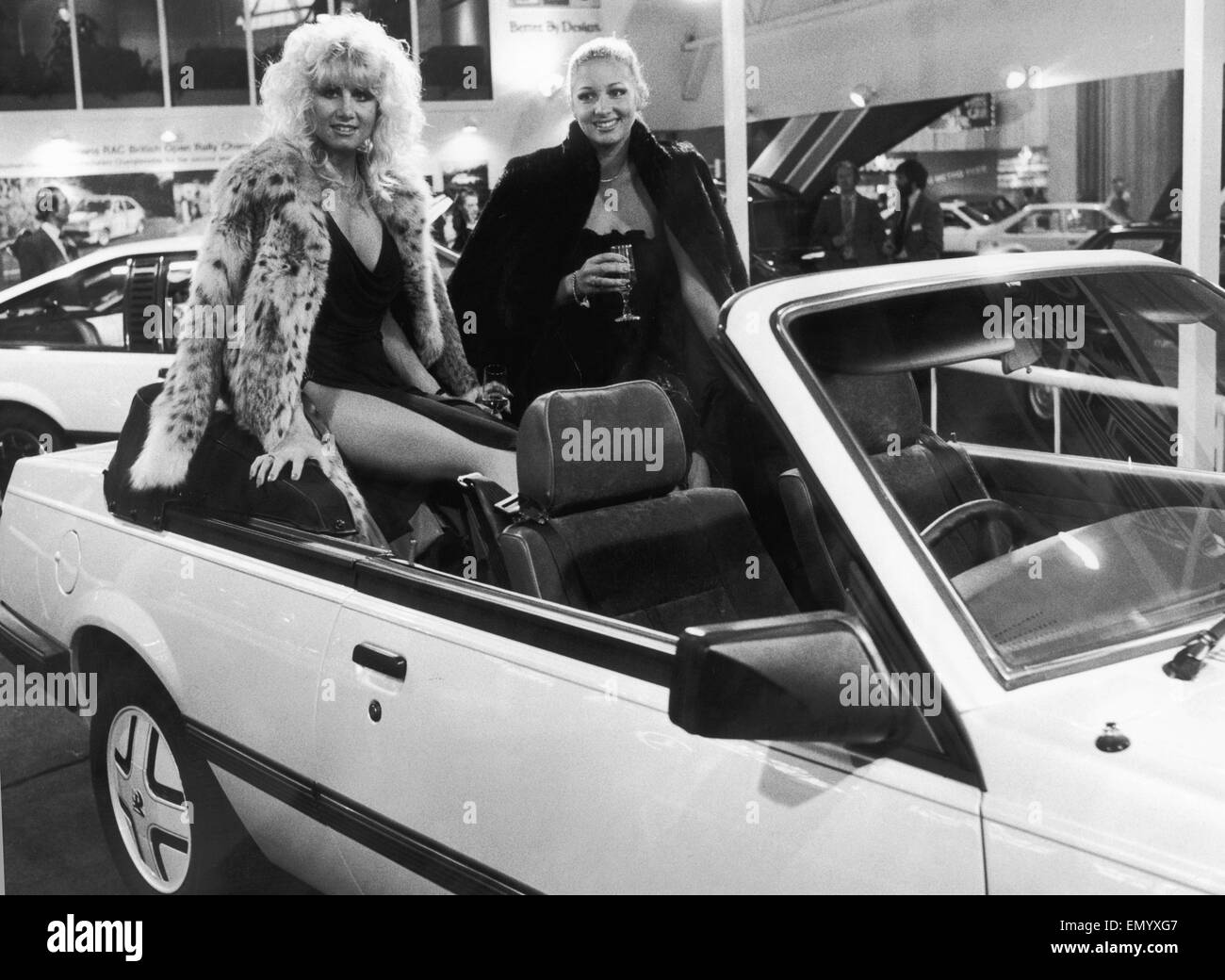 Two models pose in the backseats of the new soft top Cavalier on the Vauxhall General Motors Stand at the 1982 Motor Show . 19th October 1982 Stock Photo