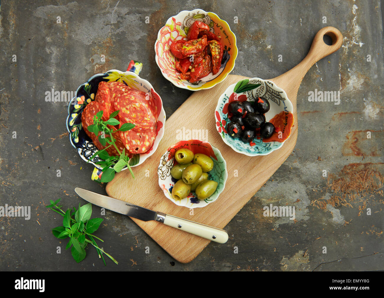 Antipasto, black and green olives, with sun dried tomato's, basil and Salami Stock Photo