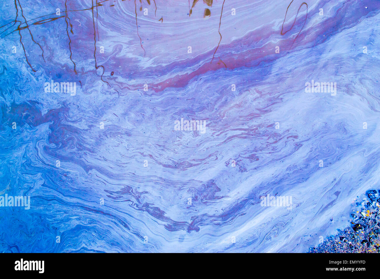Oil swirls and patterns on the surface of a stagnant pool of water ...