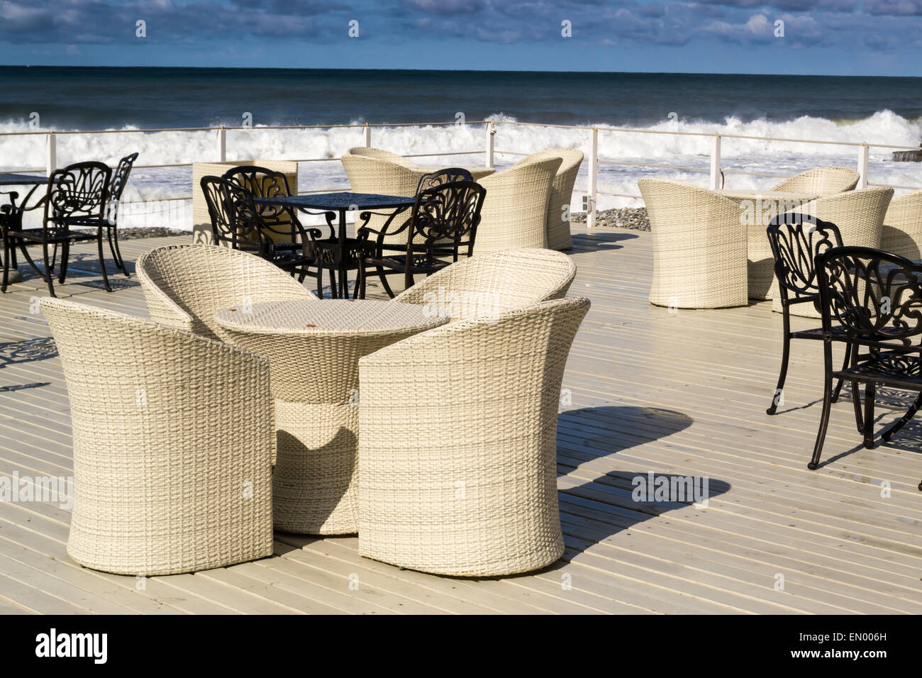 Empty Wicker And Black Iron Chairs Wait For Tourists In The Cloudy