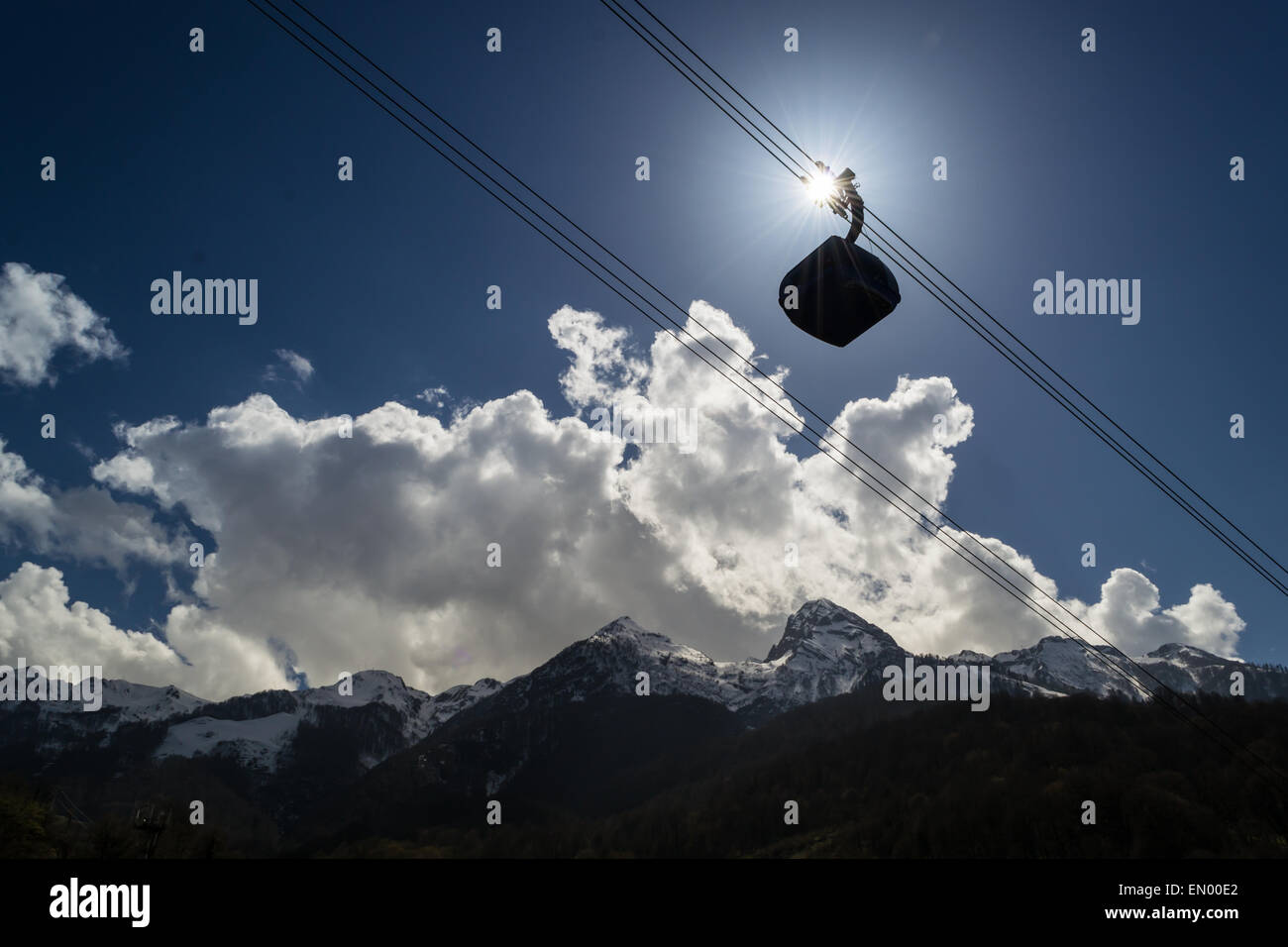 A cable car moves through the sun and a blue sky Stock Photo - Alamy