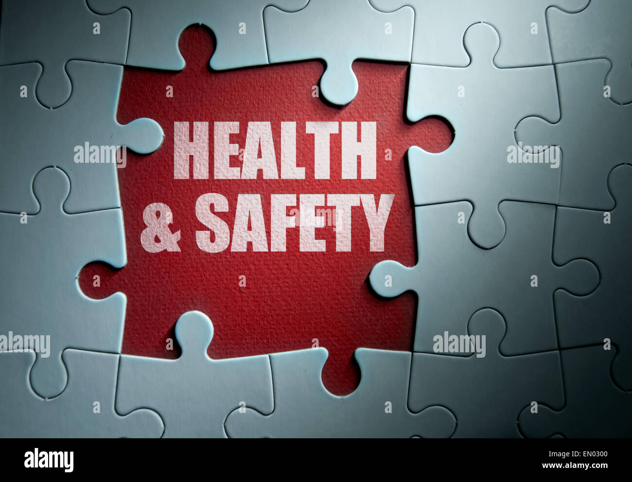 Missing pieces from a jigsaw puzzle revealing health and safety Stock Photo