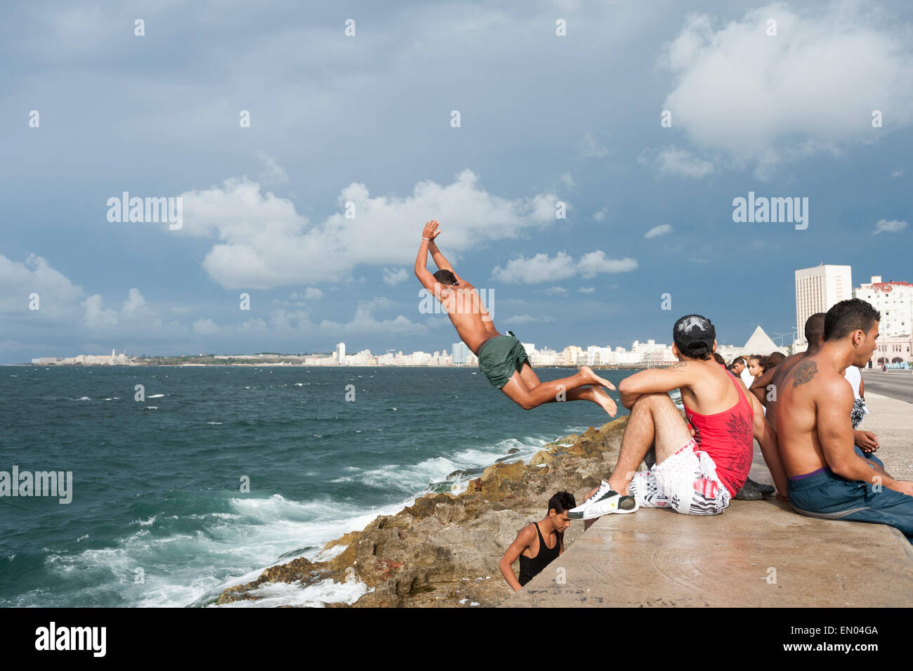 HAVANA, CUBA - MAY 23, 2011: Cubans dive into the sea at a popular swimming hole called Cueva del Tiburon on the Malecon. Stock Photo