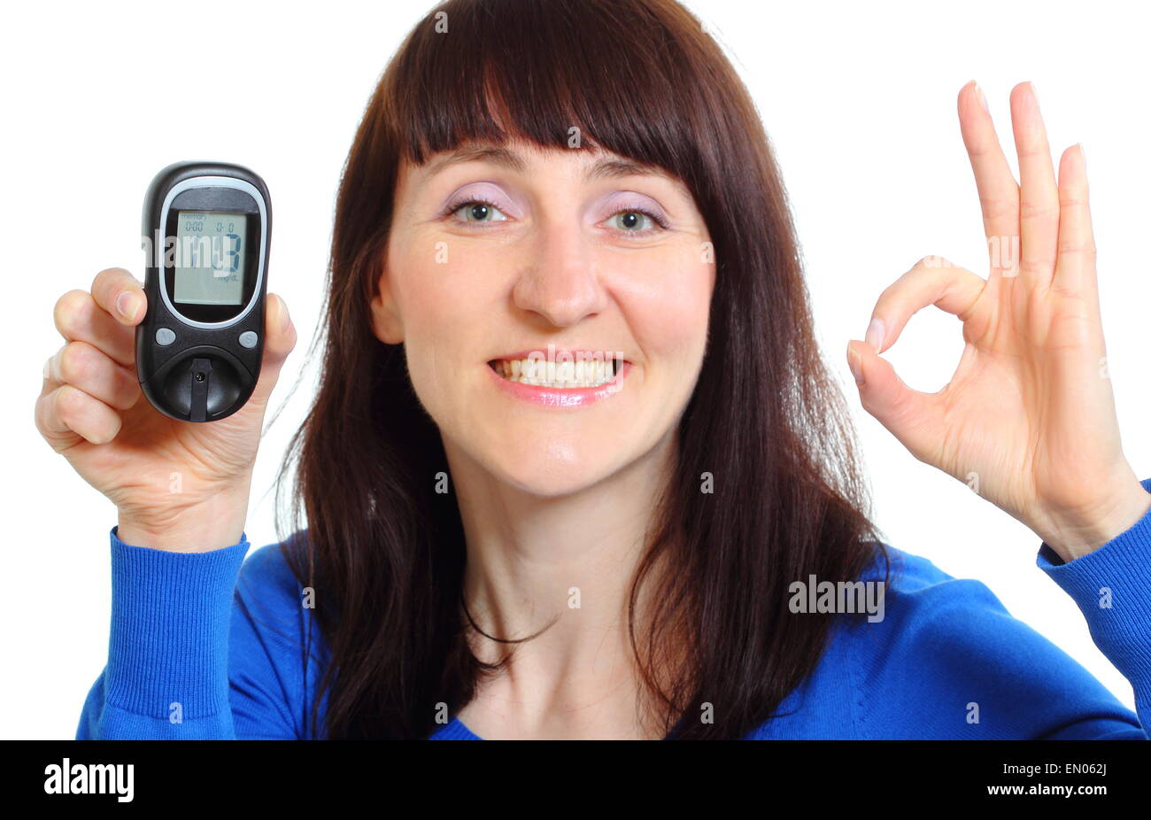 Portrait Using Glucometer Smiling woman holding glucose meter, measuring sugar level, concept for ...