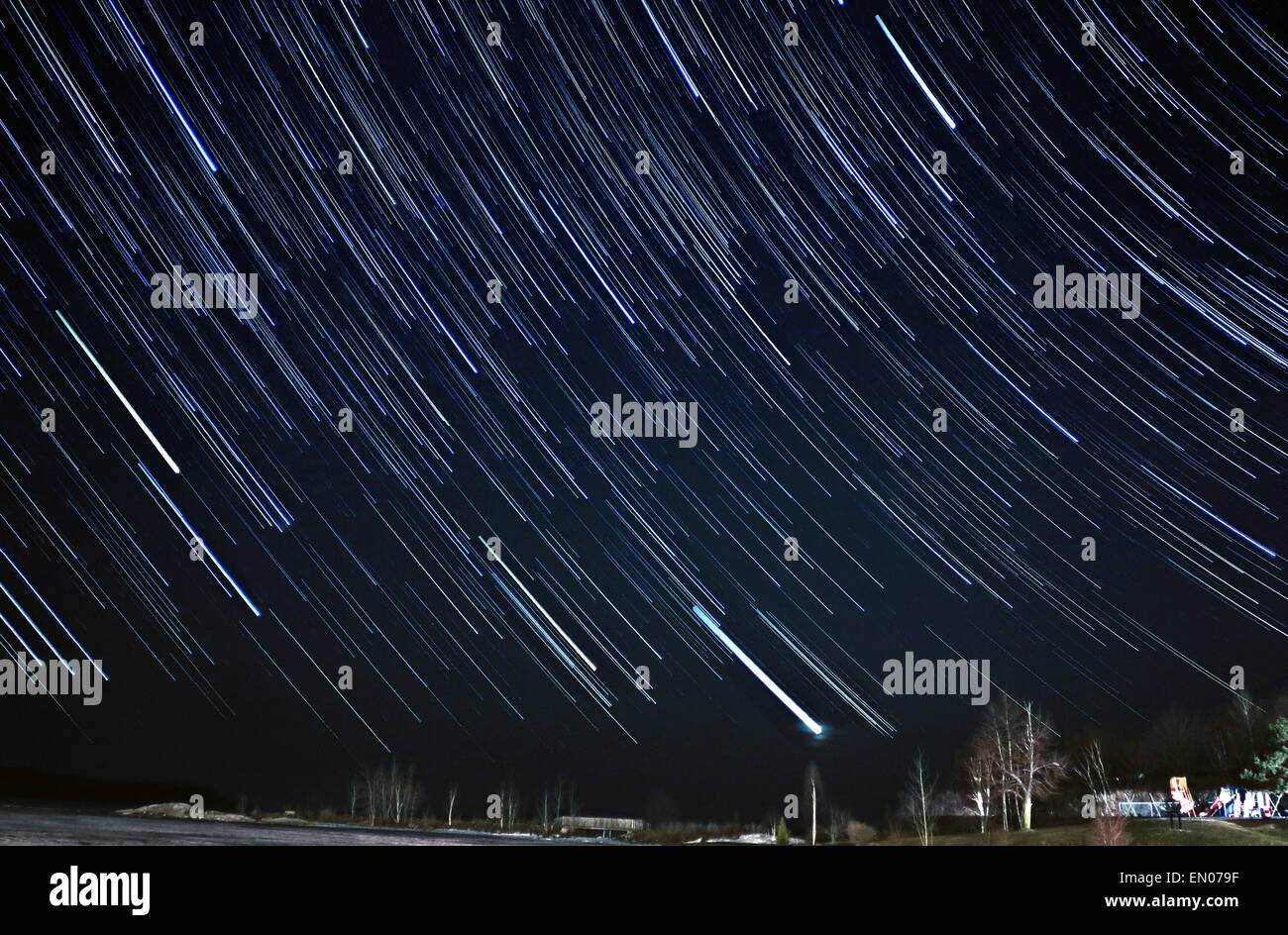 Star trails as if countless shooting stars descending from night sky to earth. Stock Photo