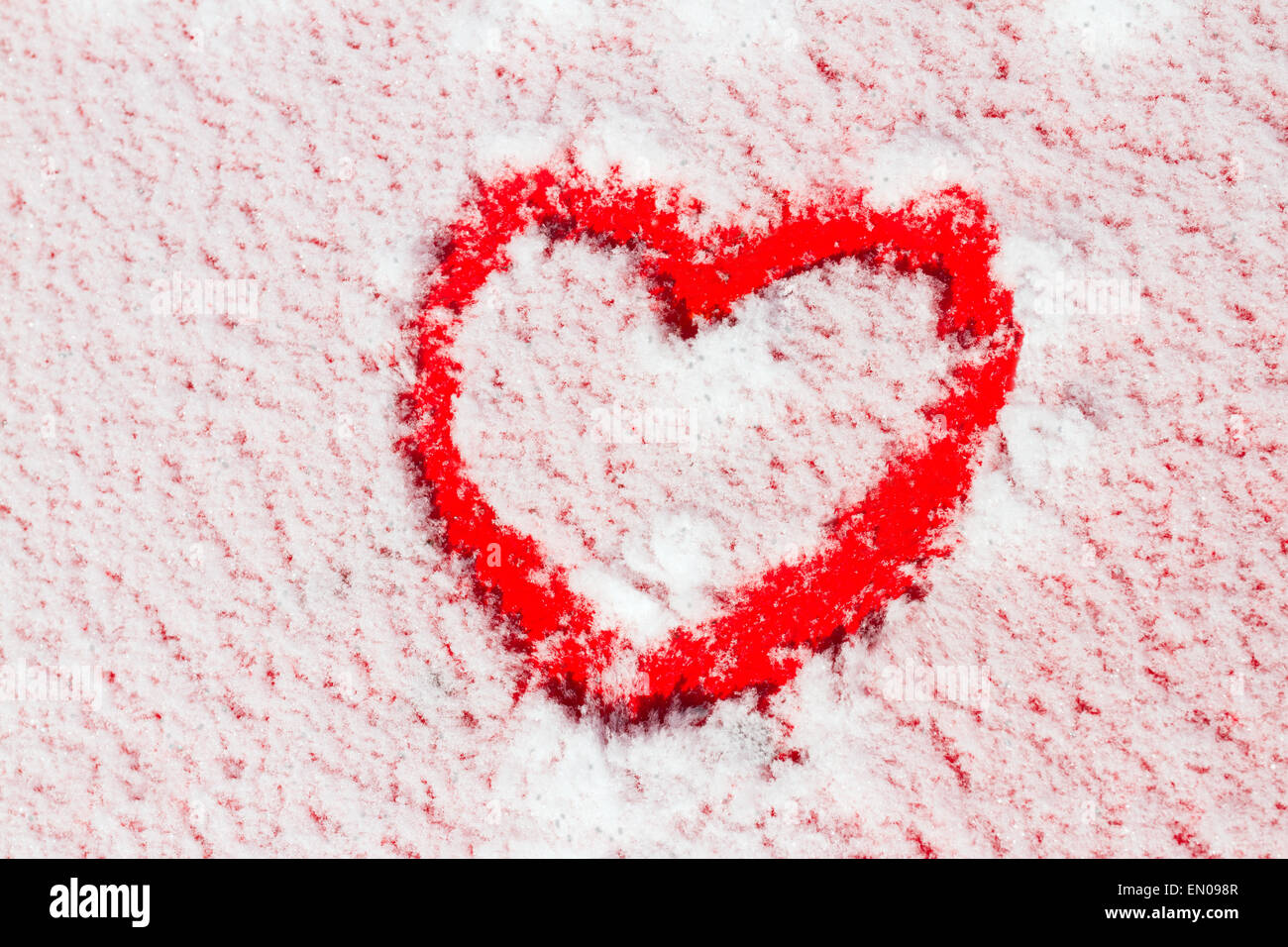 Heart shape drawn on snow Stock Photo - Alamy