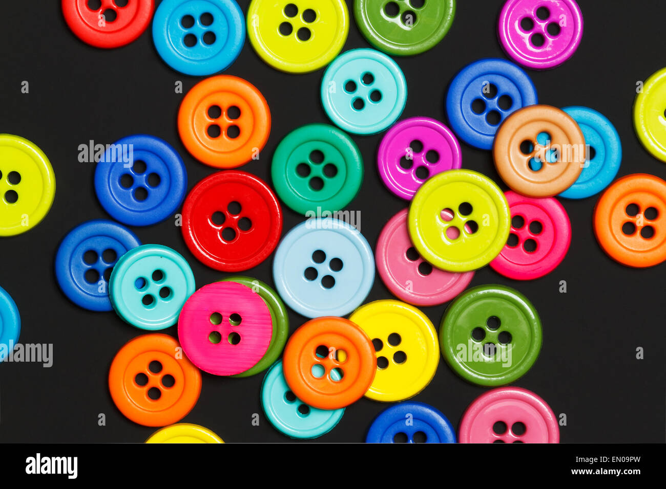 Sewing buttons on a dark background Stock Photo - Alamy
