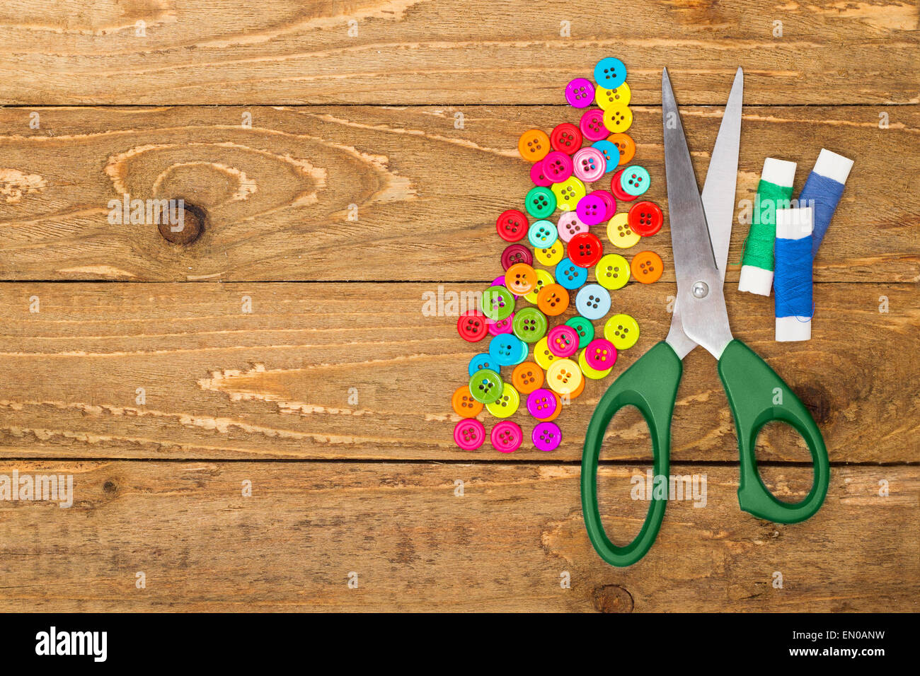 Sewing buttons, scissors and rolls of thread Stock Photo - Alamy