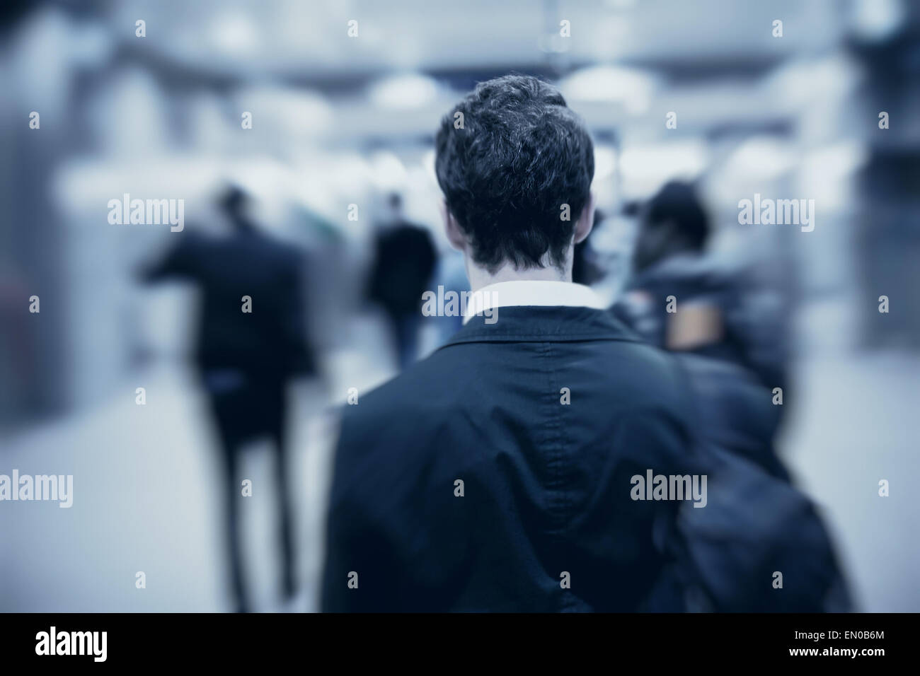 people walking in metro, blurred motion, back of the man Stock Photo