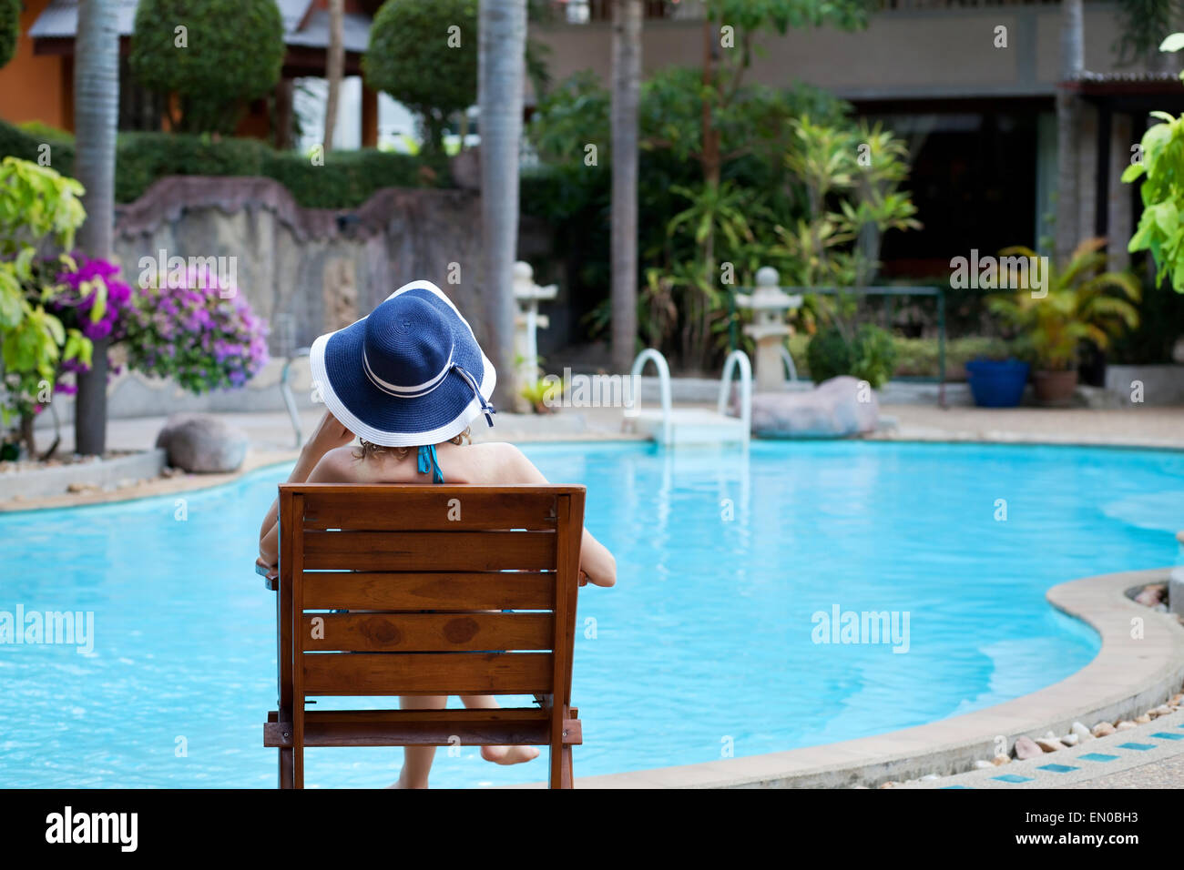 woman relaxing in luxury spa hotel near beautiful swimming pool Stock Photo