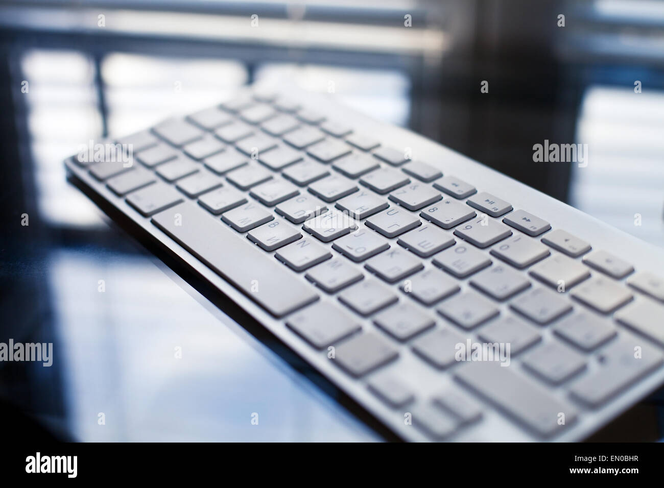 beautiful modern keyboard on the glass table Stock Photo