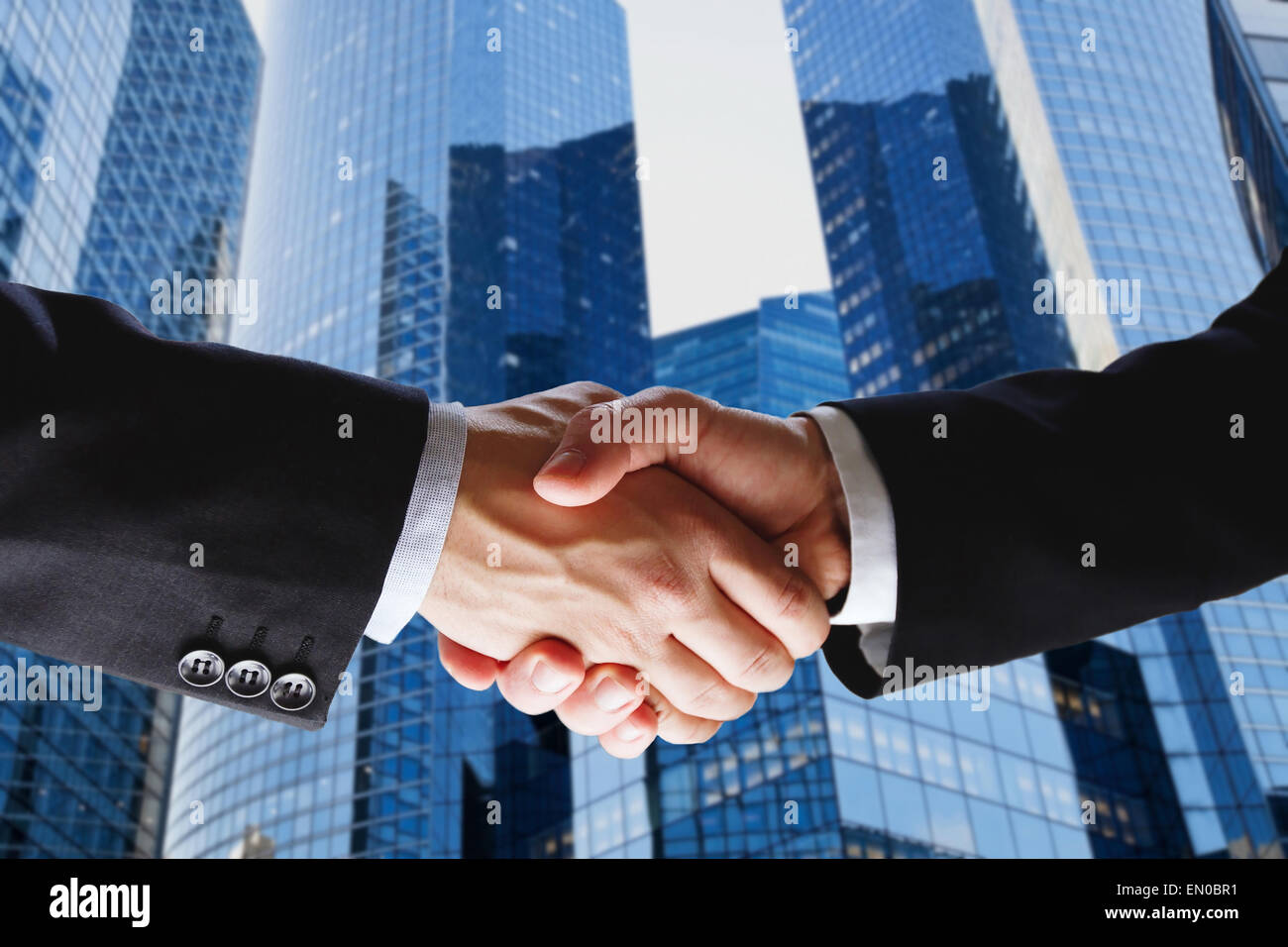 business deal, handshake on modern blue background Stock Photo