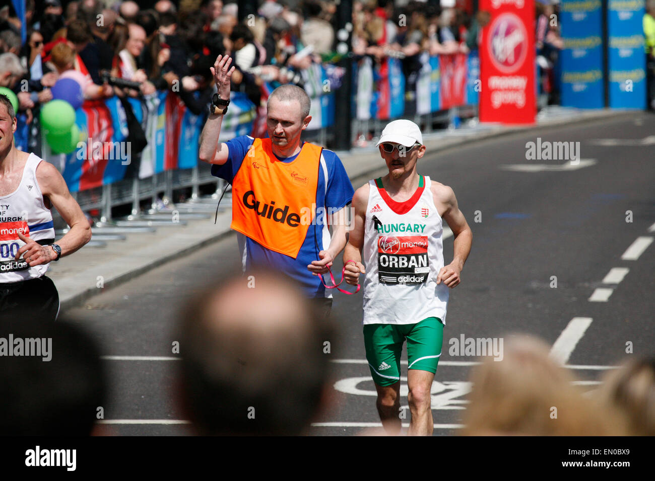 London, UK - April 21, 2013: Blind runner and guide runner are working together at London Marathon. The London Marathon is next  Stock Photo