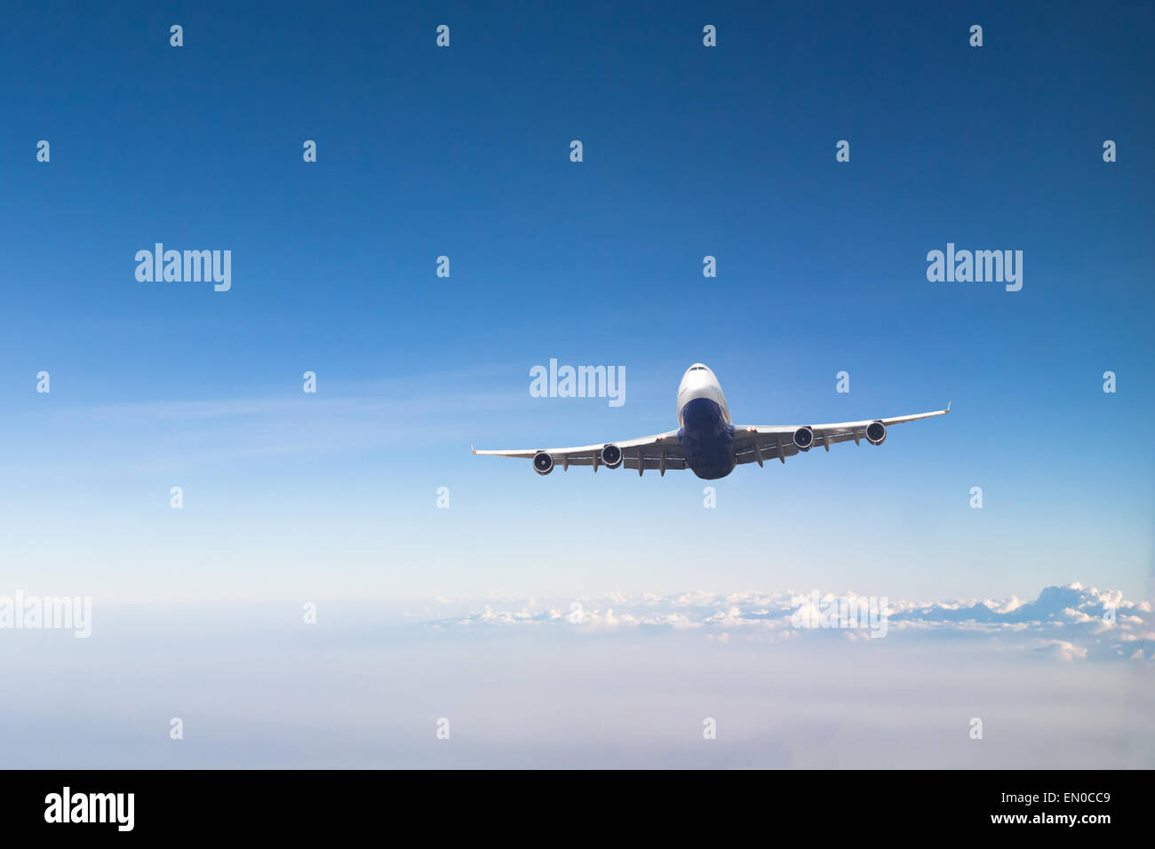 airplane in blue sky Stock Photo - Alamy