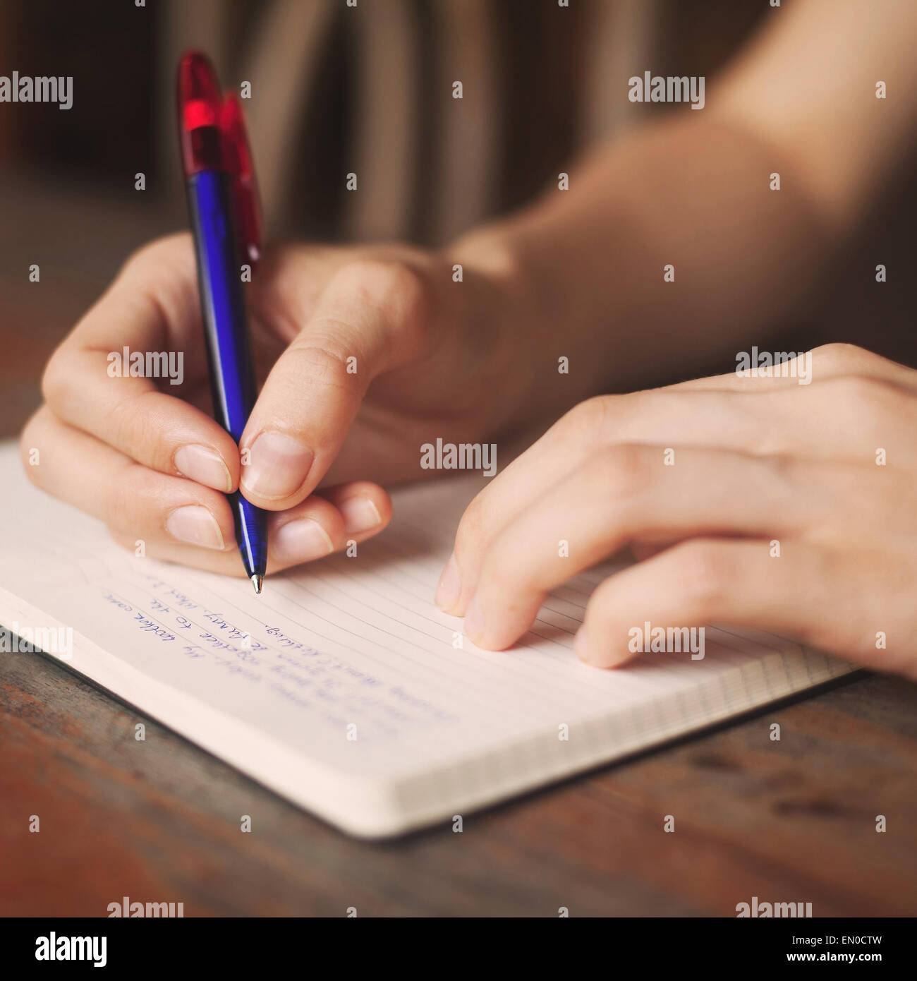 kid writes in notepad Stock Photo