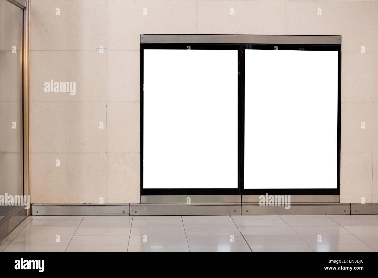 two empty white blank billboards on the wall in metro Stock Photo