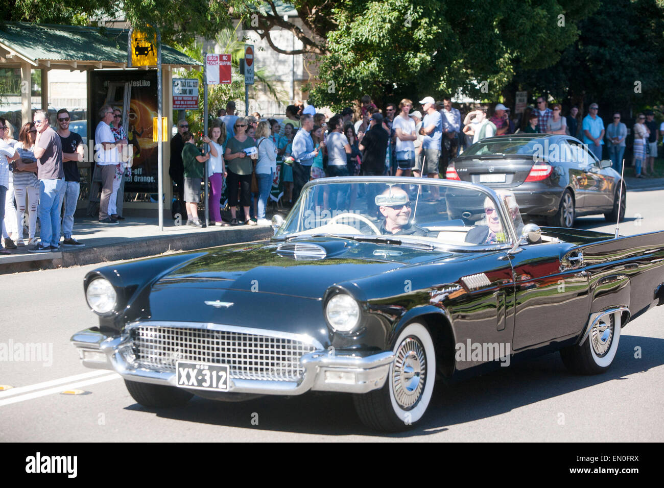 Sydney, Australia. 25th Apr, 2015. Centenary ANZAC day remembrance service at Palm beach Sydney Australia and march on 25th april to remember those who perished in world war one at Gallipoli, here an elderly veteran is given a lift in a Ford thunderbird classic car Credit:  martin berry/Alamy Live News Stock Photo