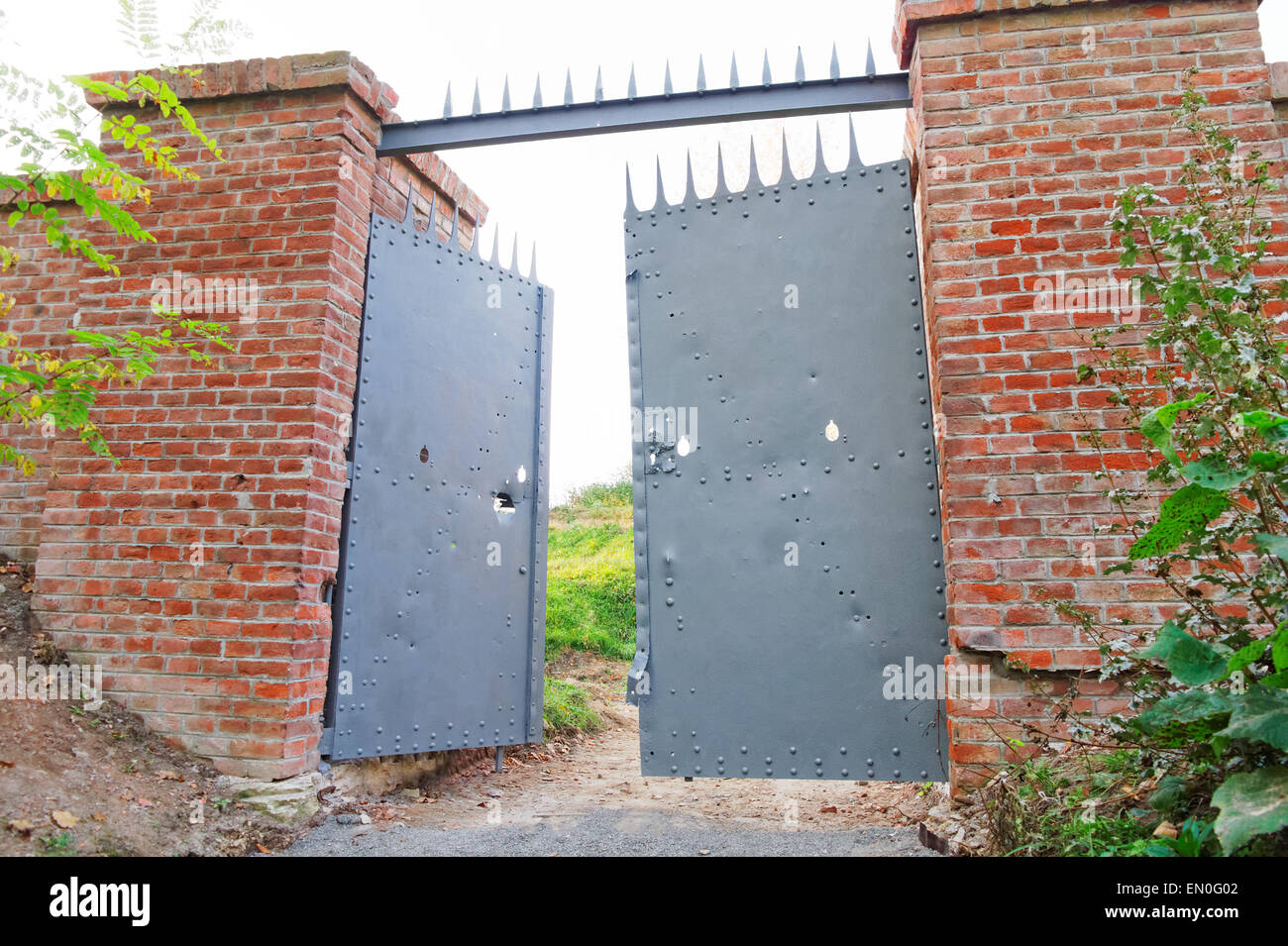 opened old damaged metal gate to the fortress Stock Photo Alamy