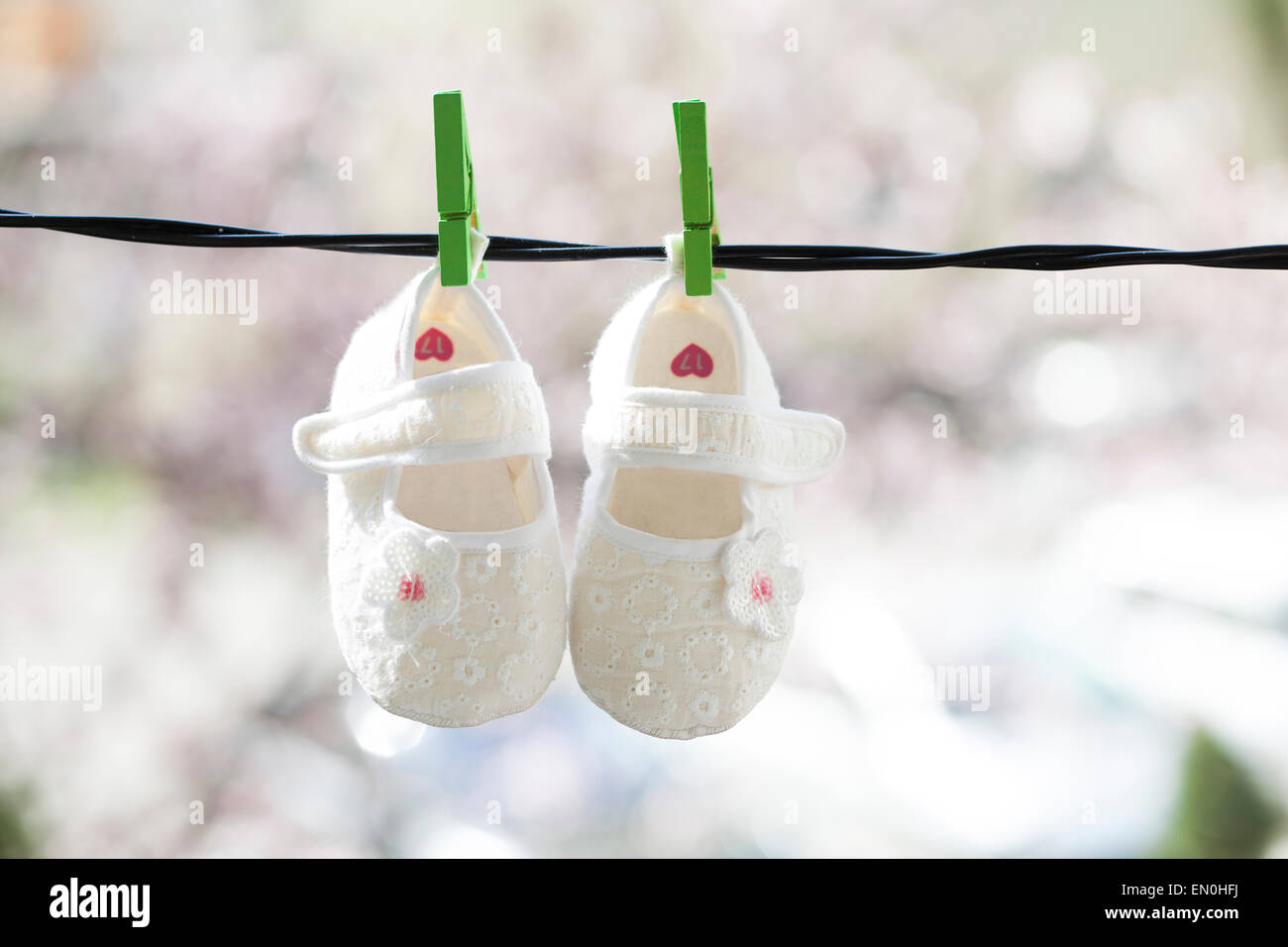 Baby shoes hanging on the clothesline Stock Photo Alamy