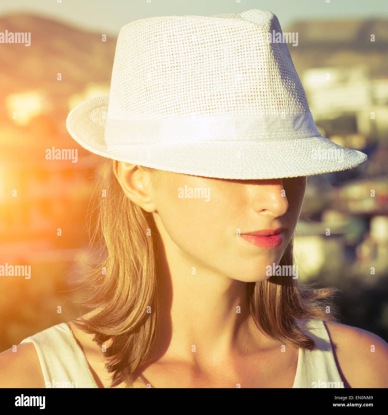Young woman wearing white hat on a sunny day Stock Photo - Alamy