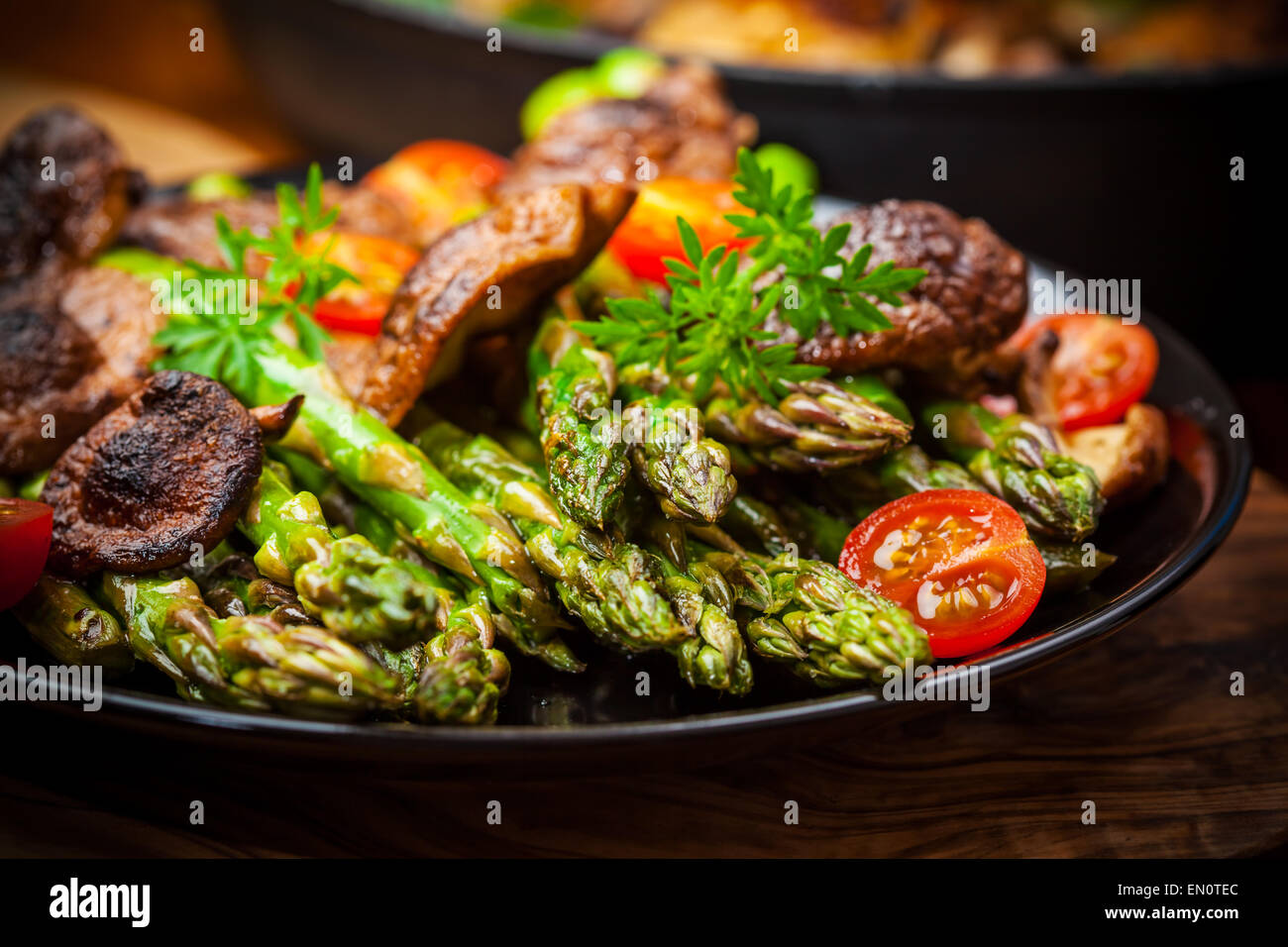 Green asparagus salad with roasted mushrooms and red wine Stock Photo