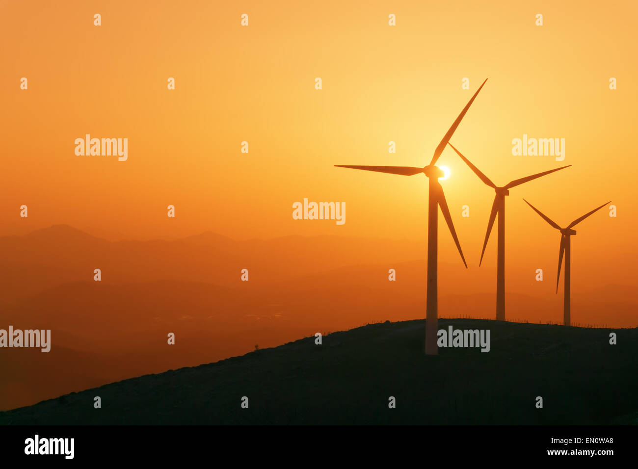 wind turbines silhouette on mountain at the sunset Stock Photo - Alamy