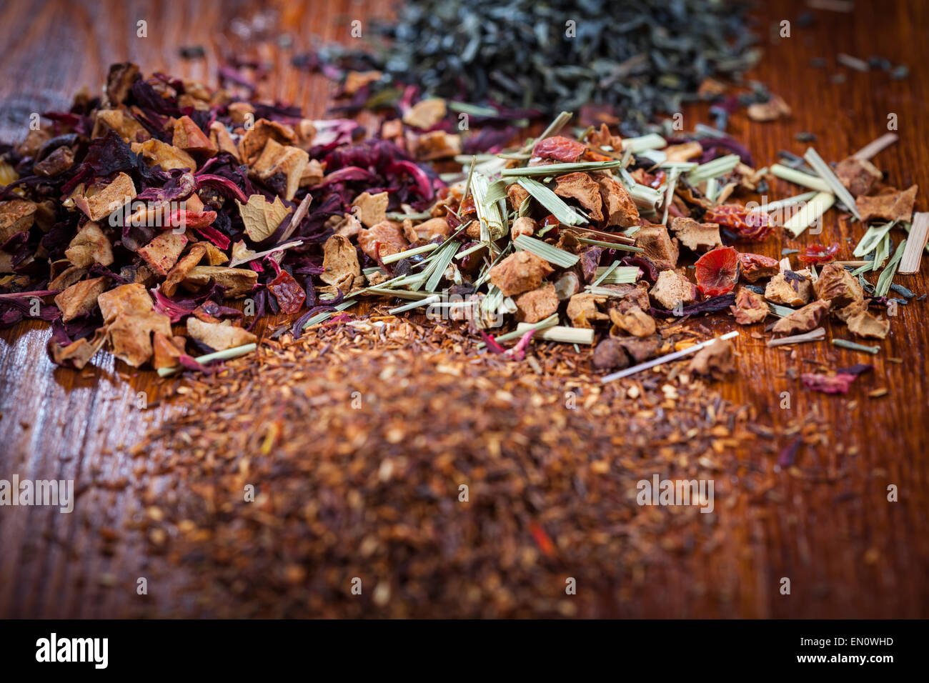 Assortment of dry tea on wooden table Stock Photo