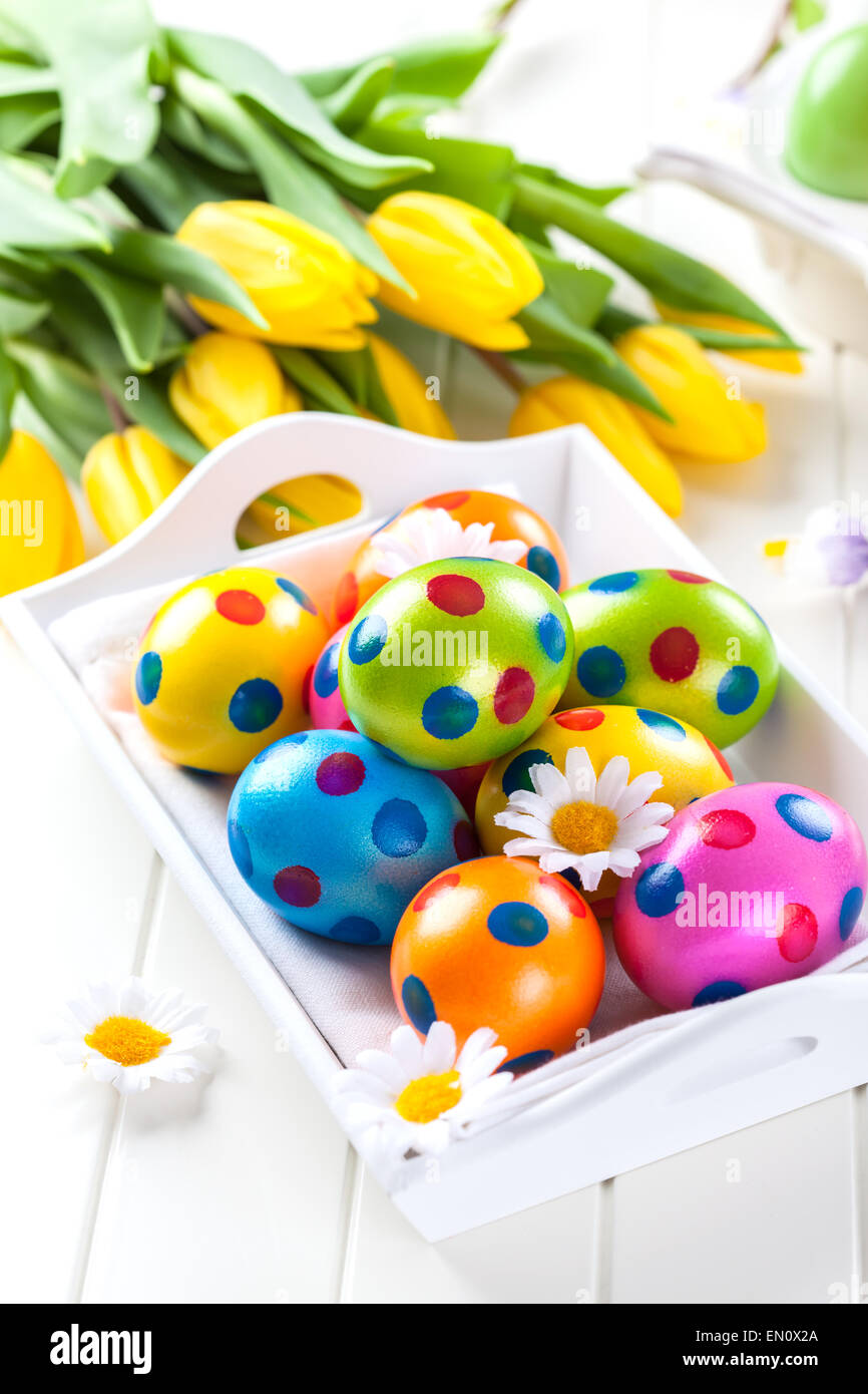 Easter eggs with spring flowers decorating table Stock Photo - Alamy