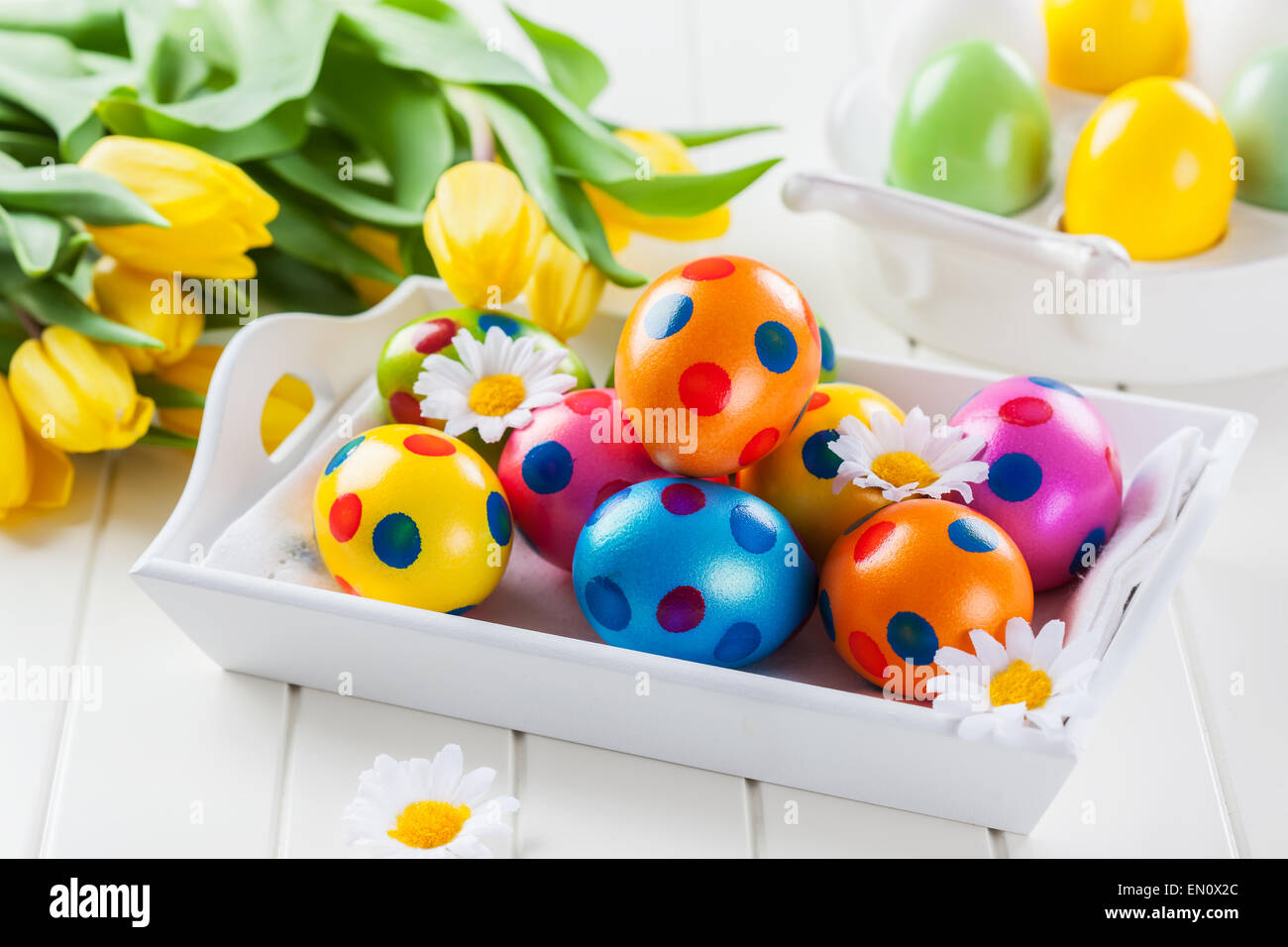 Easter eggs with spring flowers decorating table Stock Photo - Alamy