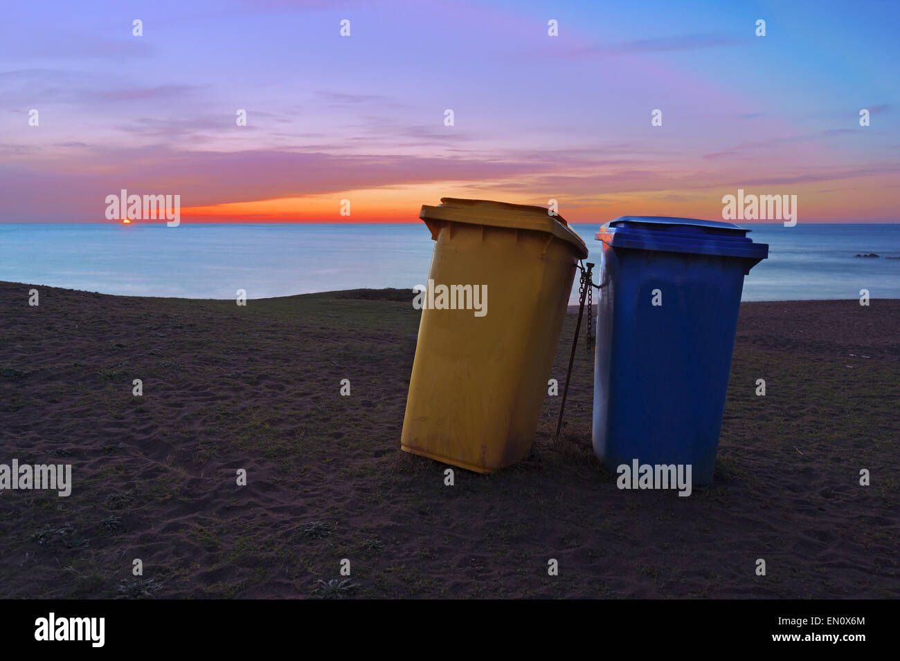 two paper bins on beach at sunset Stock Photo