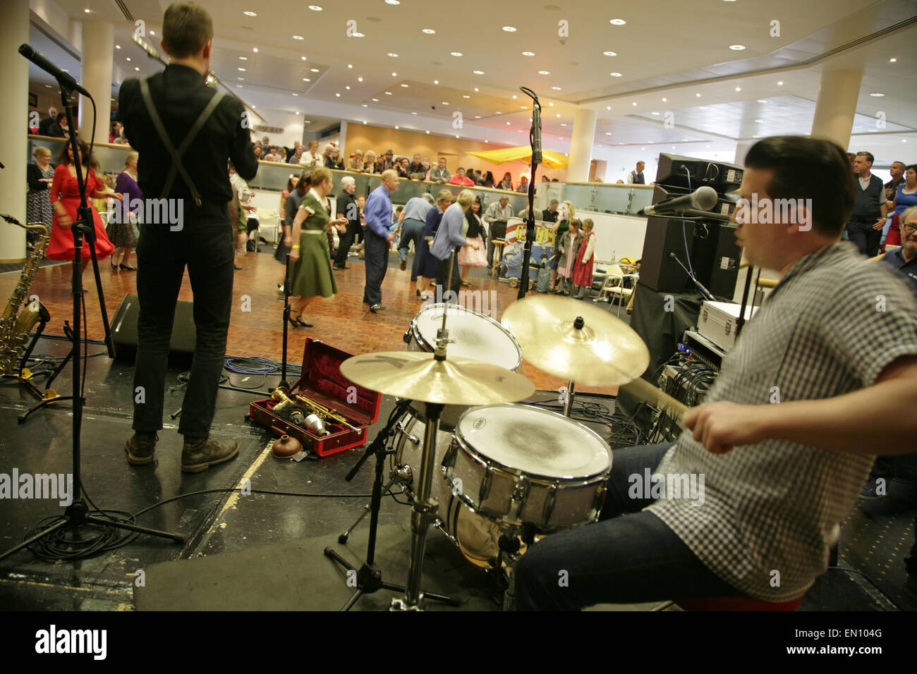 York, UK, 25 April 2015. 'The Jive Aces' jive and swing band entertain visitors to the Festival of Vintage at York Racecourse: an event showcasing and celebrating the fashion, beauty, cars, motorcycles, music and lifestyle from the 1930's to 1960's. Credit:  david soulsby/Alamy Live News Stock Photo