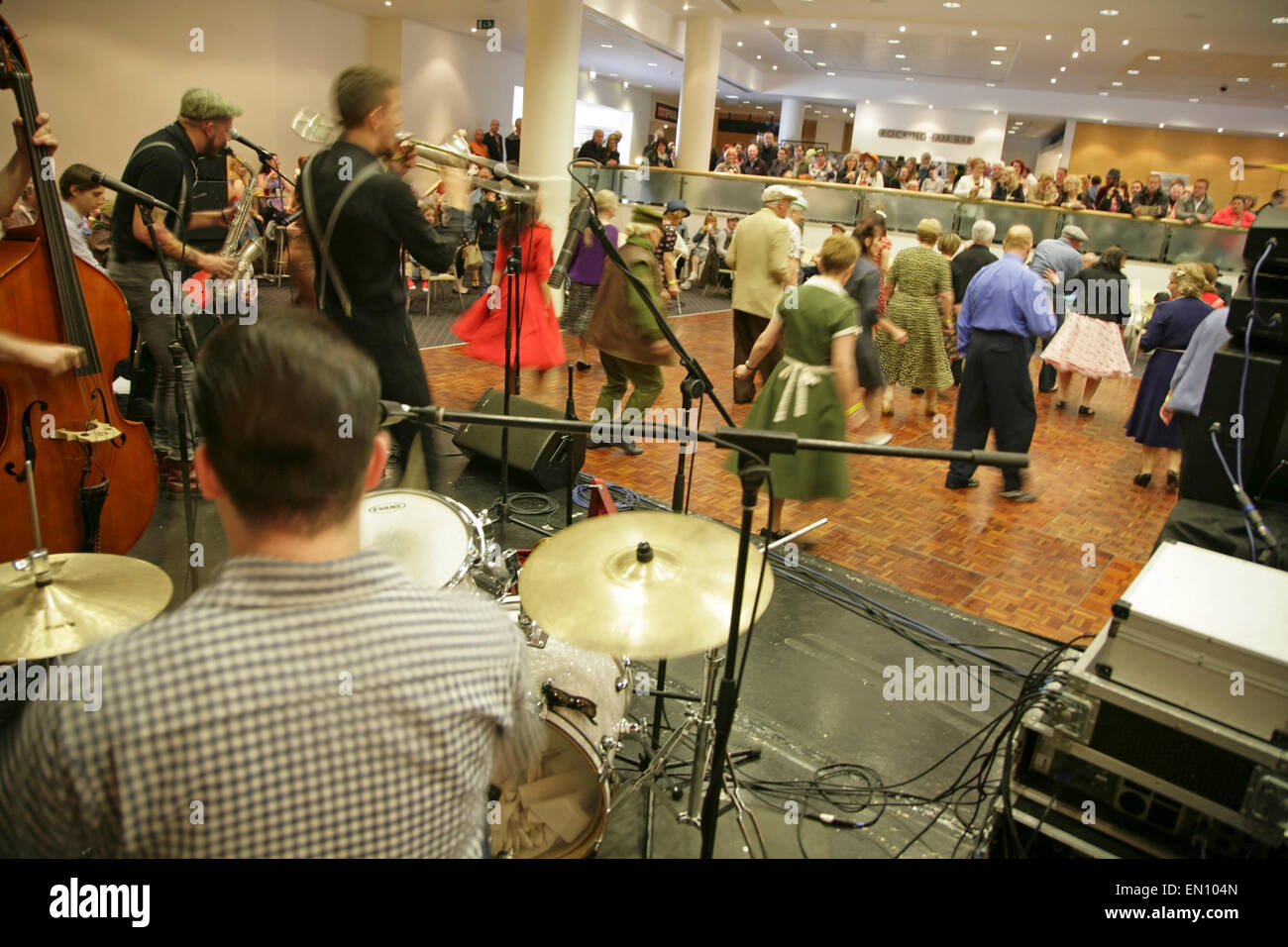 York, UK, 25 April 2015. Visitors dance to classic songs played by 'The Jive Aces' jive and swing band at the Festival of Vintage at York Racecourse: an event showcasing and celebrating the fashion, beauty, cars, motorcycles, music and lifestyle from the 1930's to 1960's. Credit:  david soulsby/Alamy Live News Stock Photo